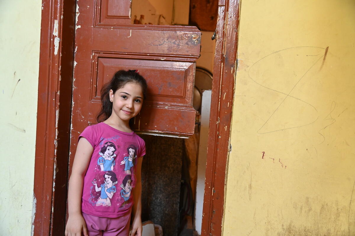 Girls stands by a broken door