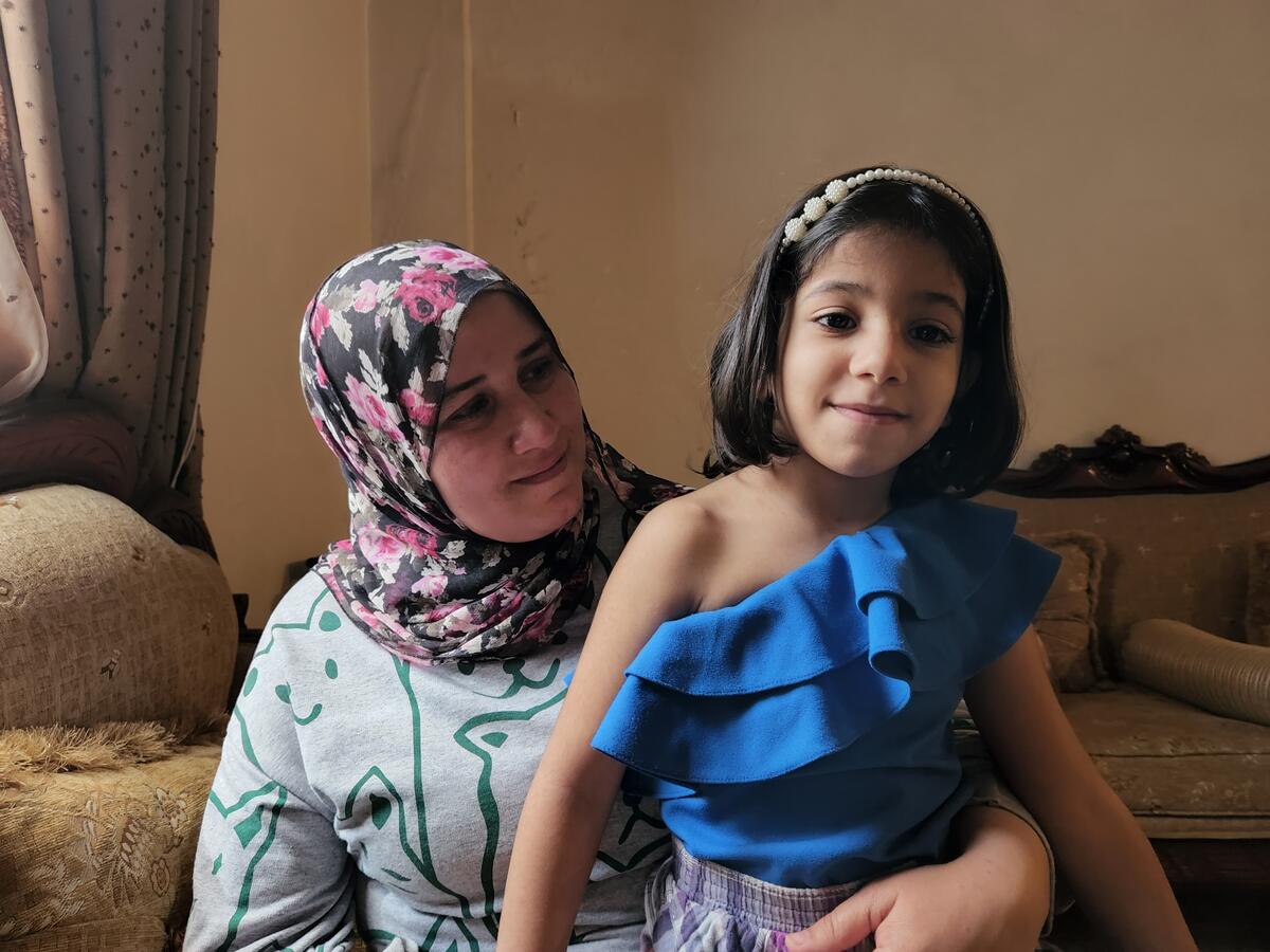 Safaa who lives in Akkar holding her daughter.