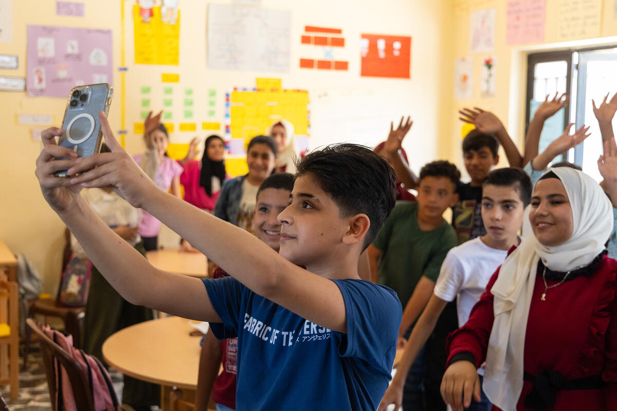 a young boy in Lebanon takes a selfie with family and friends