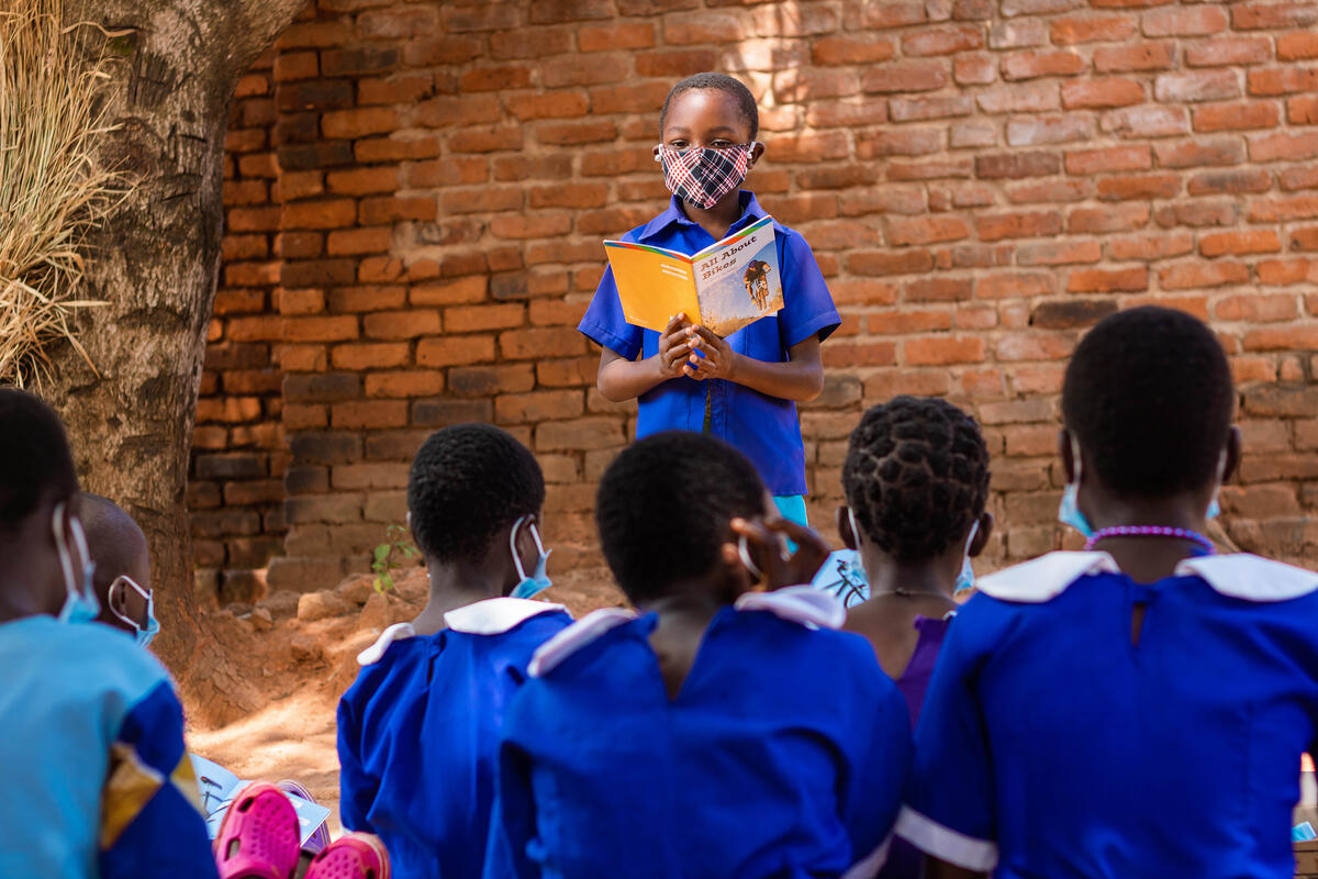Phillip teaches his classmates at their school in Malawi.