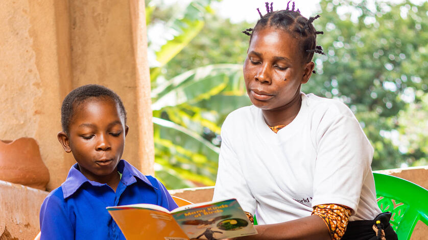 Asiyileni and her son Phillip read at home.