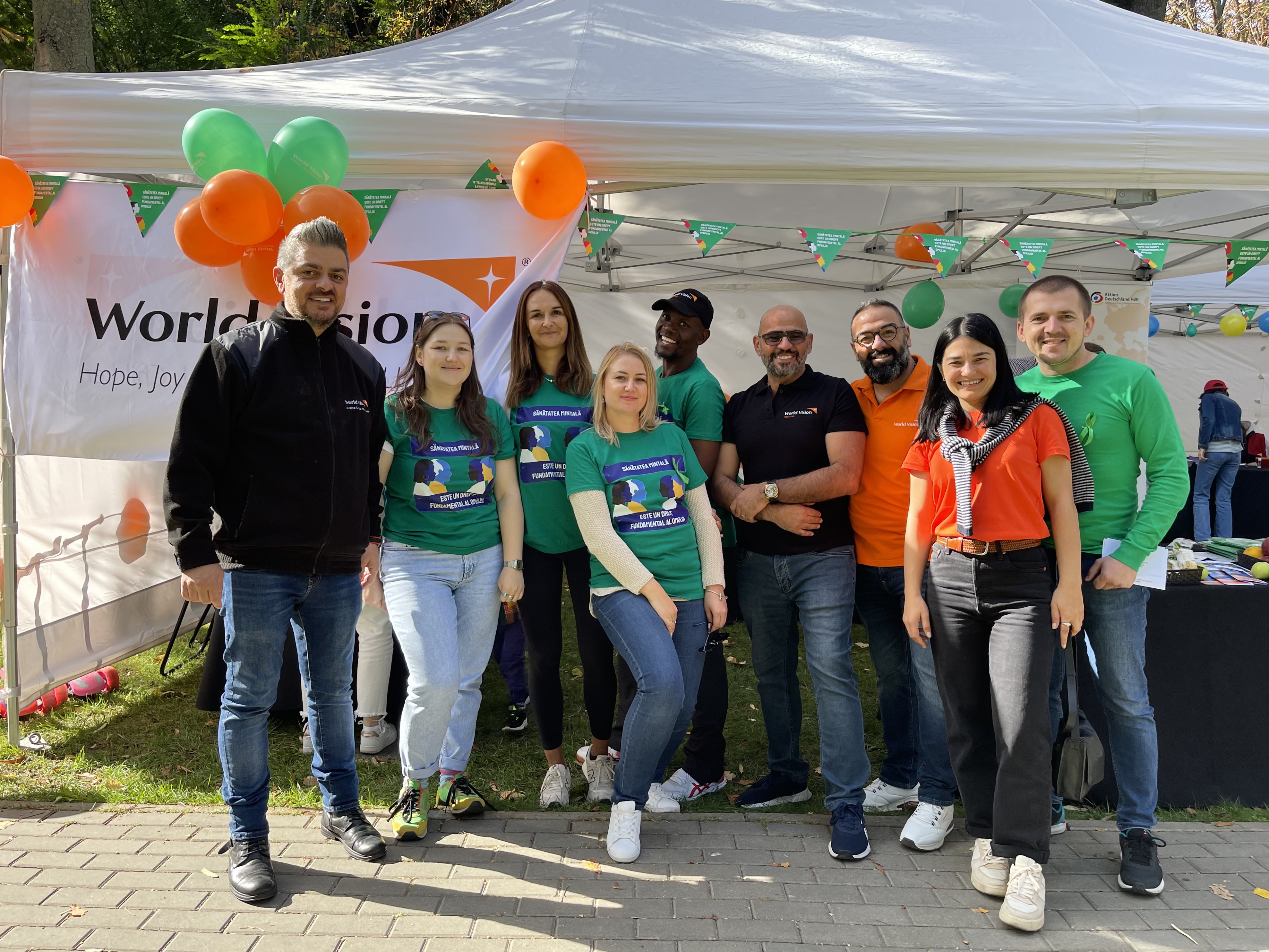 World Vision staff member smile at the camera during a Mental Health Awareness event.