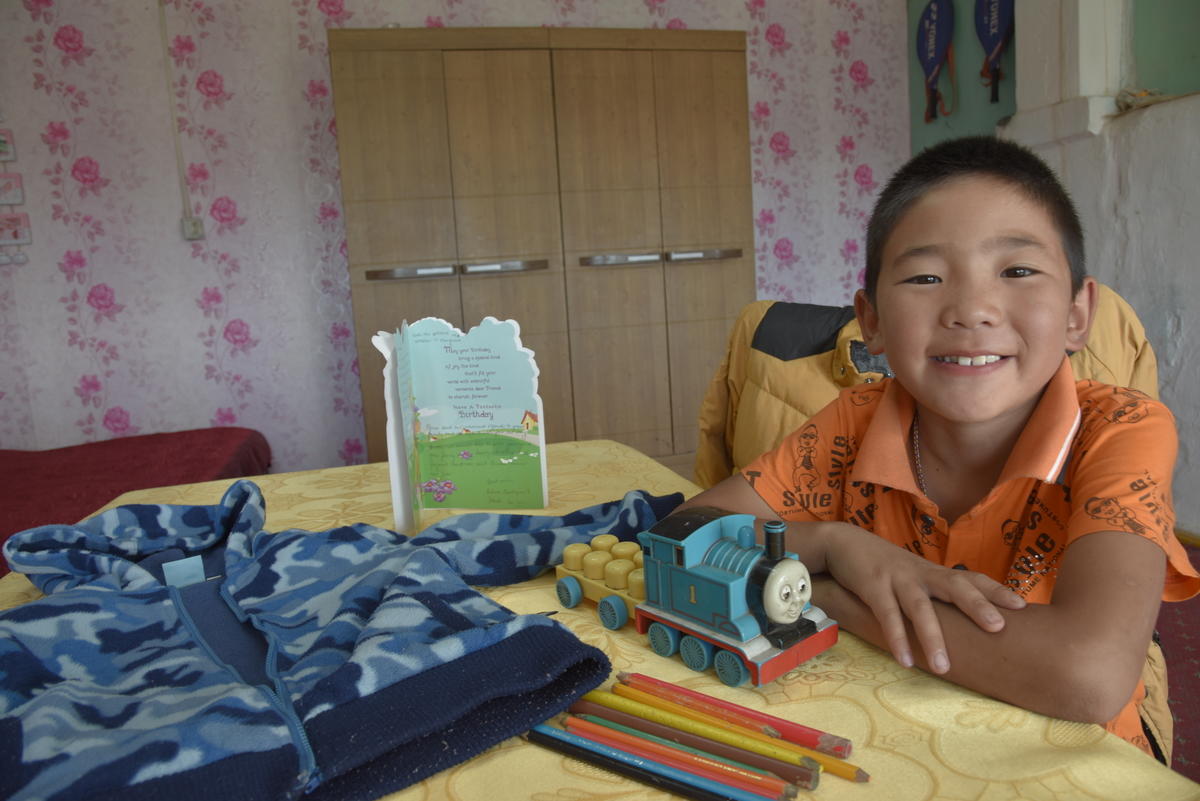 Sponsored child Otgonnyam loves the gifts from his sponsor.
