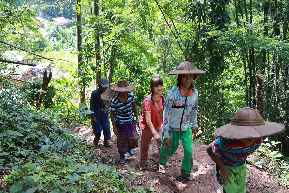 The family walk to start their farming.