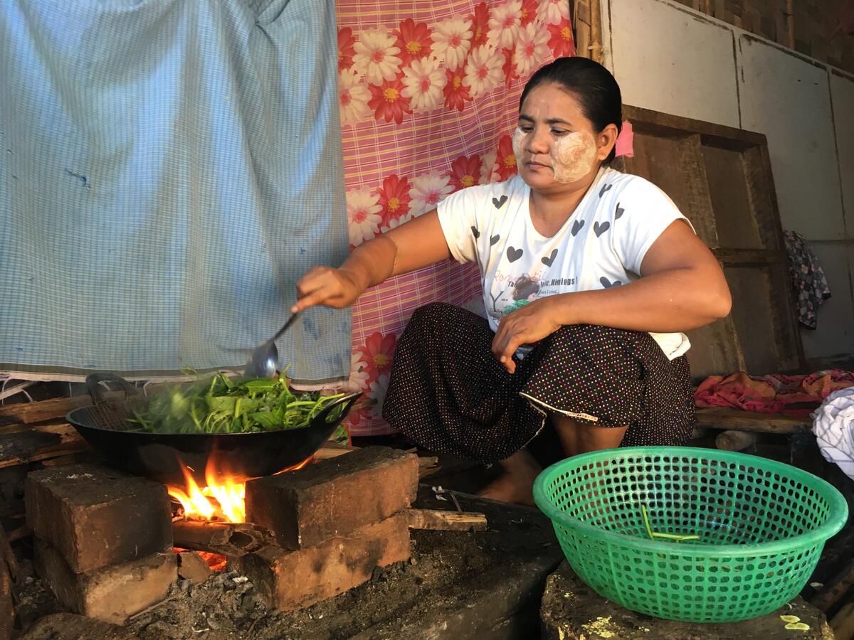 Myint, May's aunt, preparing food
