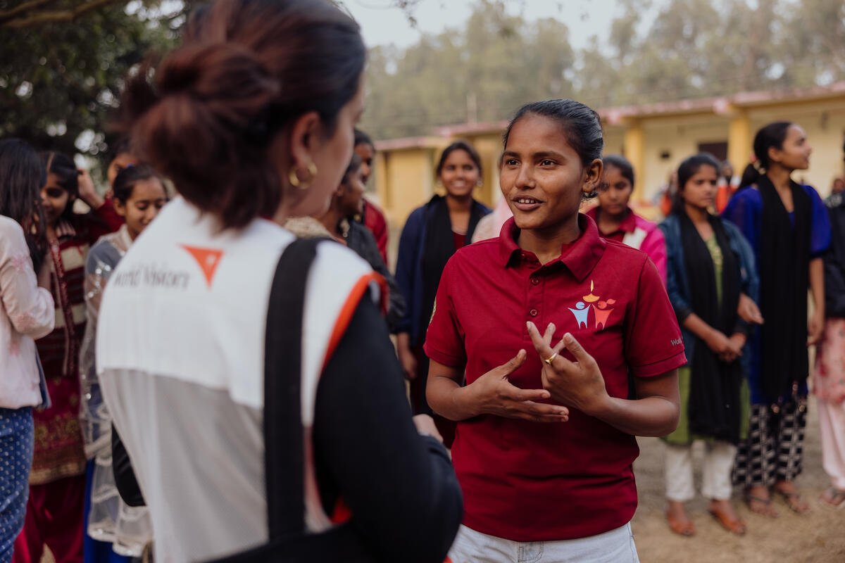Neha talking to a World Vision staff