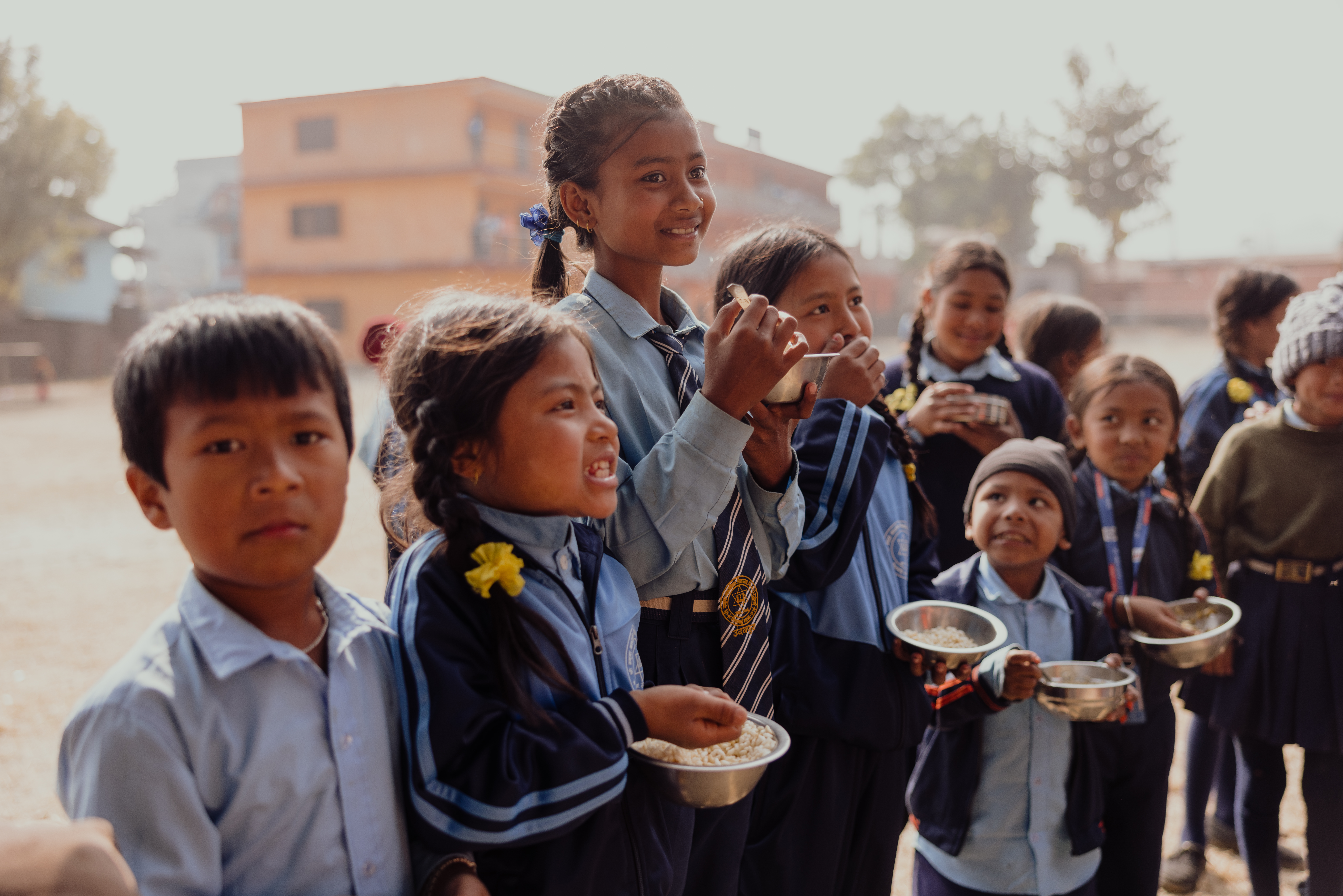 A joyful moment as children share their daily meal from the school meals programme/ Nepal 2025.