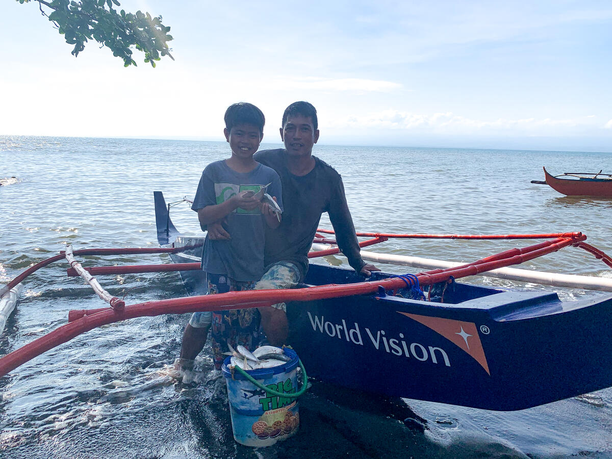 Kent and his father Albert with their fibreglass boat.