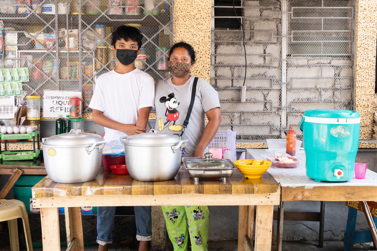 Jhayrus and his mother at their stall outside their home.