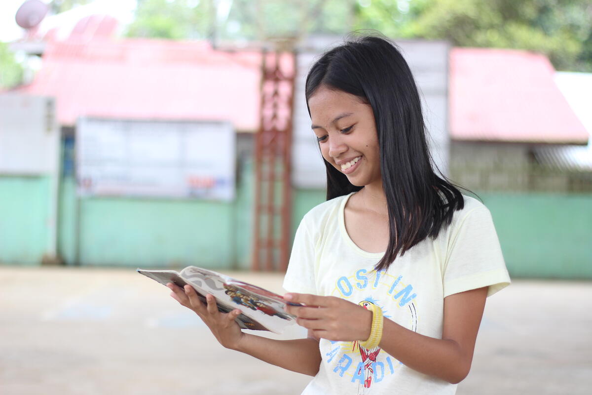 Cyra reading her Bible in the Philippines.