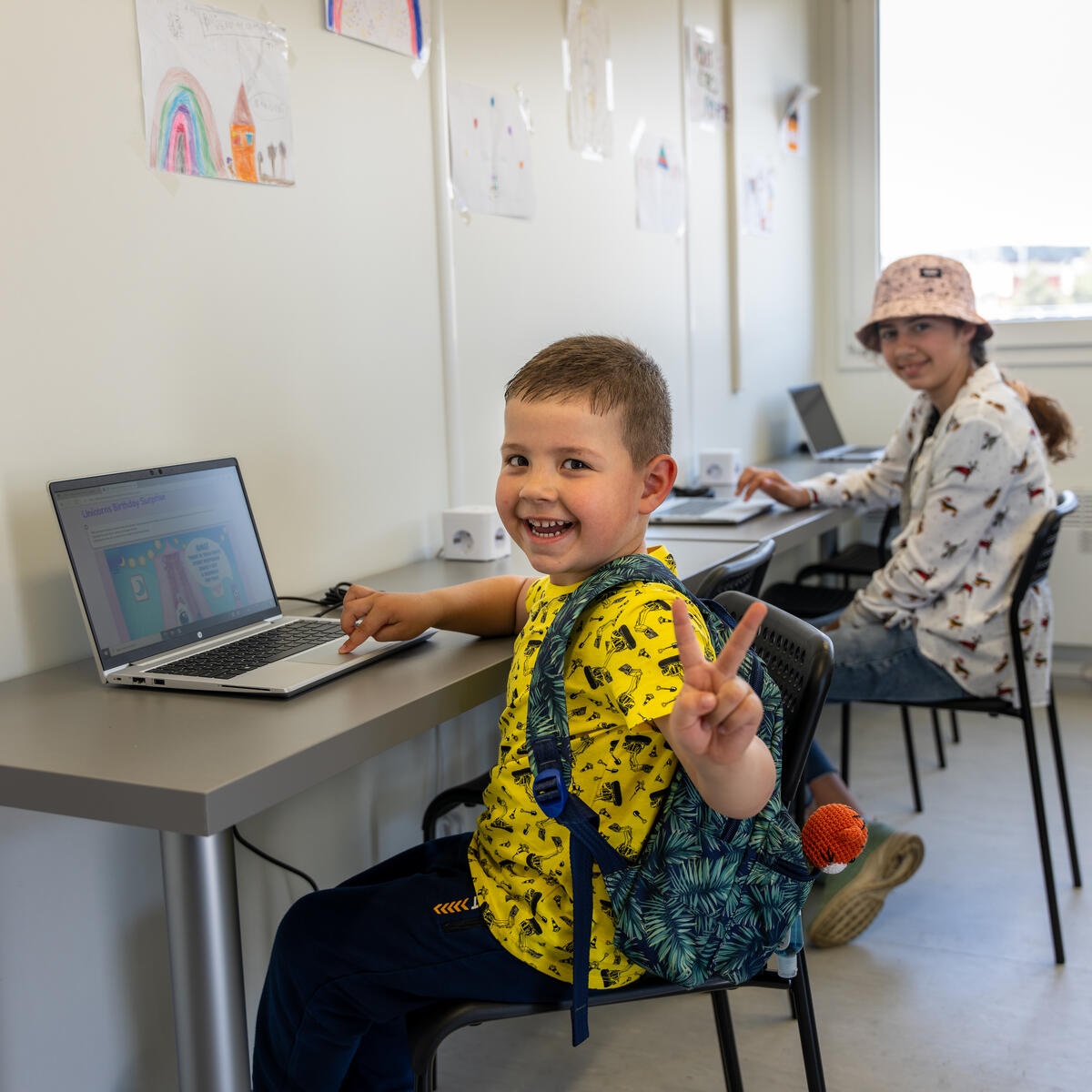 4-year-old Ukaranian Child, Kiril, is happy to use a computer at the Portable Connectivity Center established by World Vision