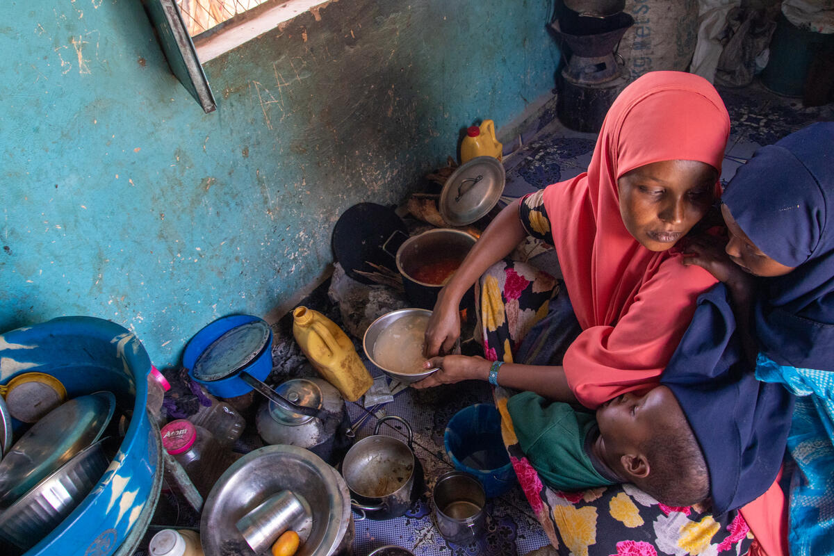 Mother cooks food for her child