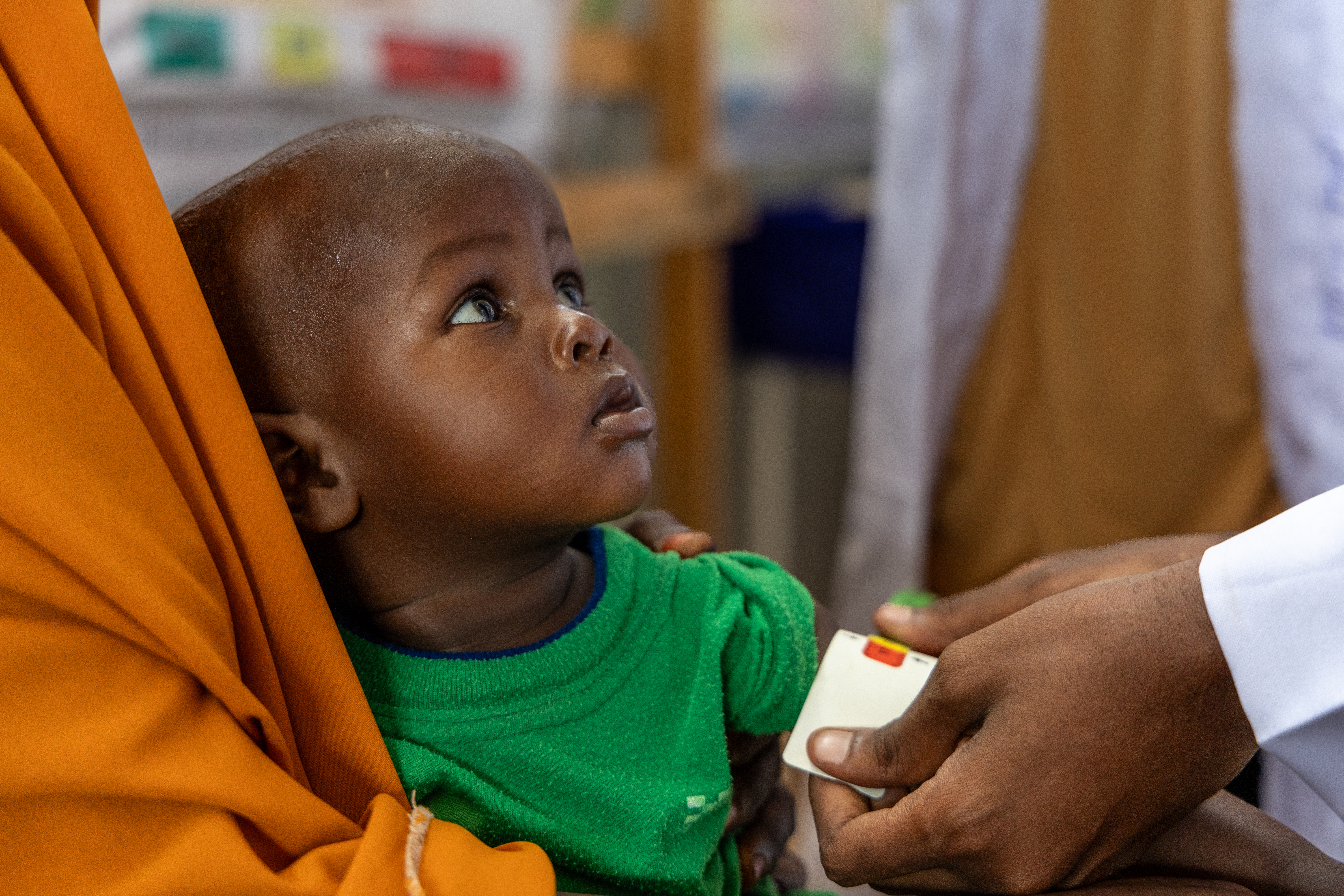 A health worker measures a child’s nutrition status at Tugarey IDP camp in Baidoa