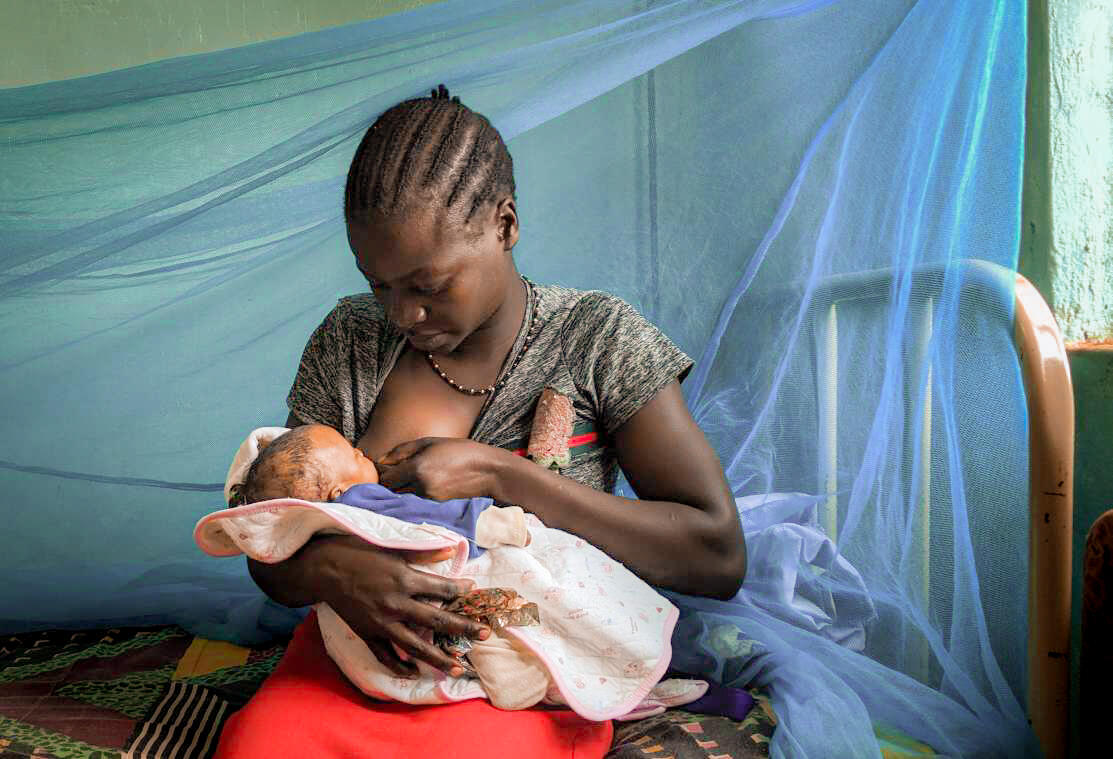 Viola breastfeeds her daughter in South Sudan.