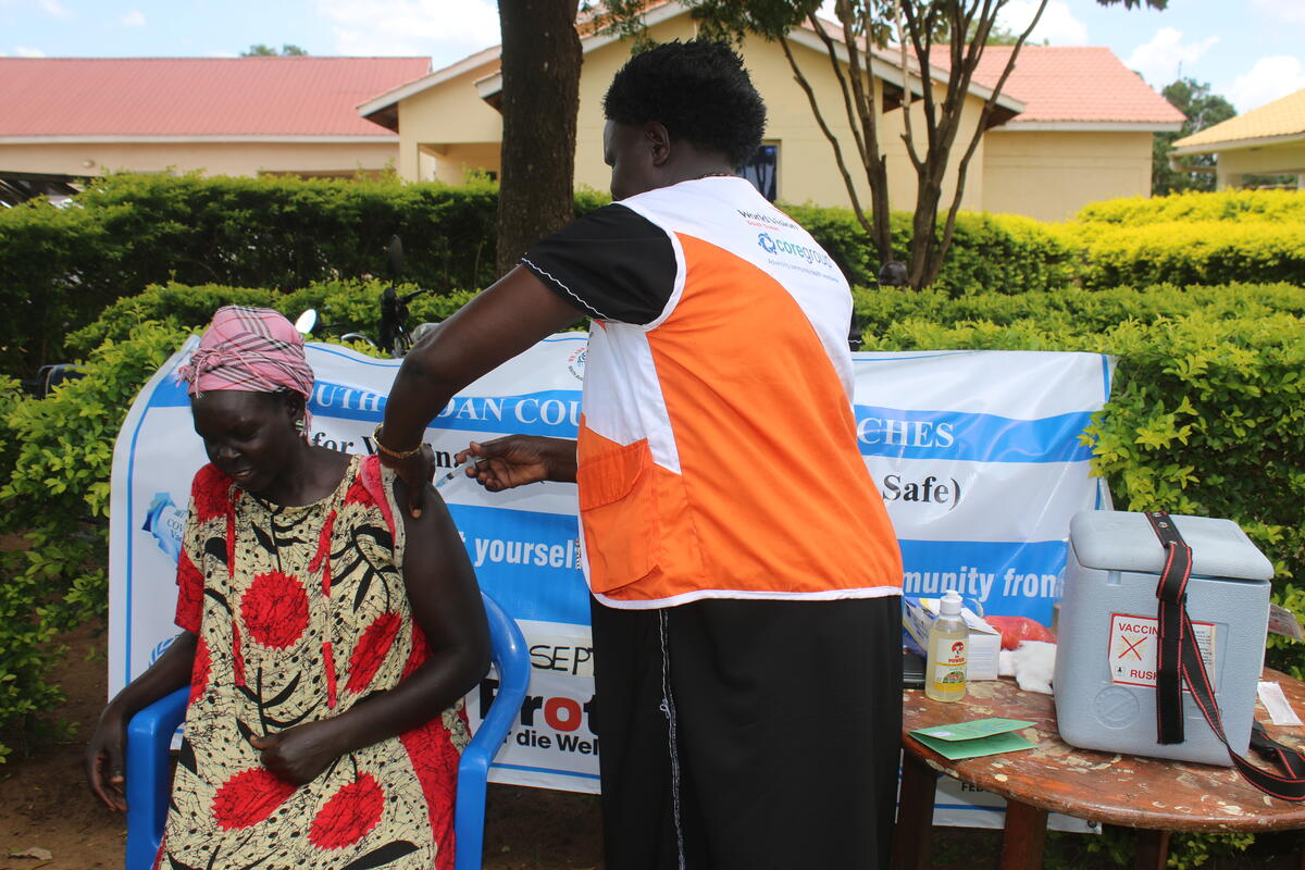 Rev. Jane Dudu, a nurse by profession, administers a vaccination