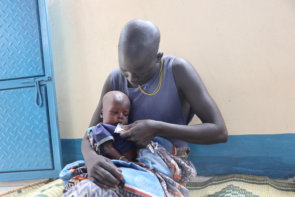 woman feeding baby