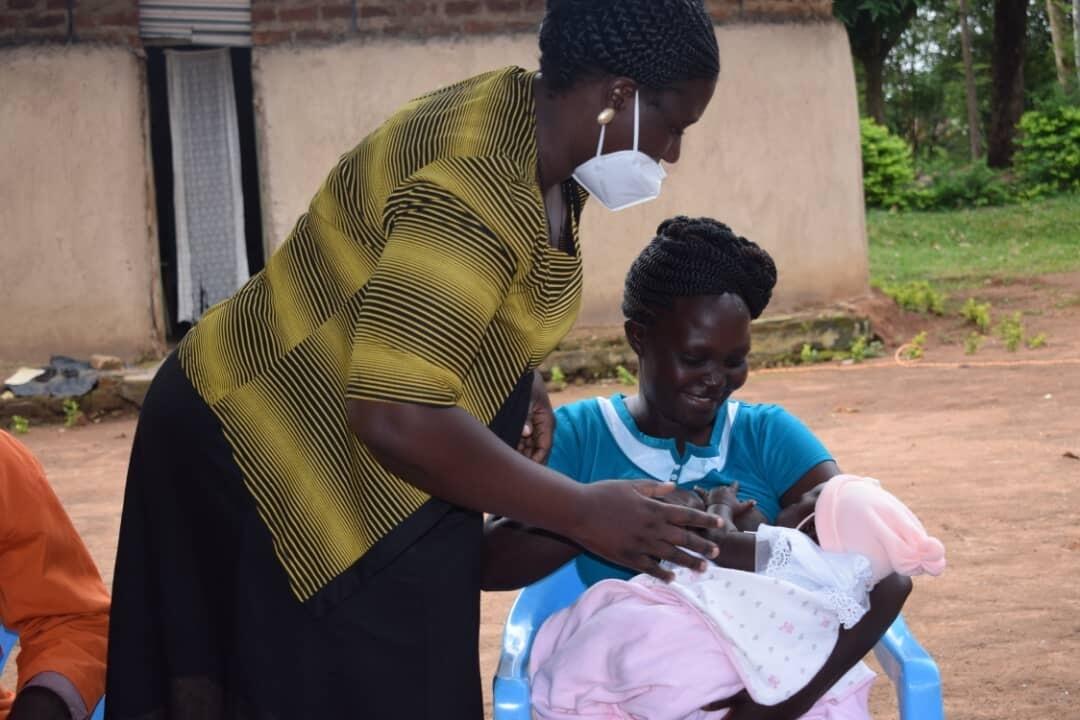 A lead mother trained by World Vision under AIM Health Plus project shows a mother how to place a baby well for breastfeeding. World Vision promotes breastmilk as the perfect food for newborns, and exclusive breastfeeding for at least six months.