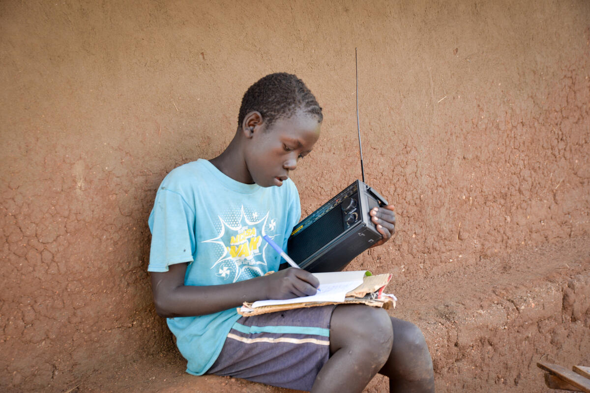 Isaac uses a radio to access his lessons