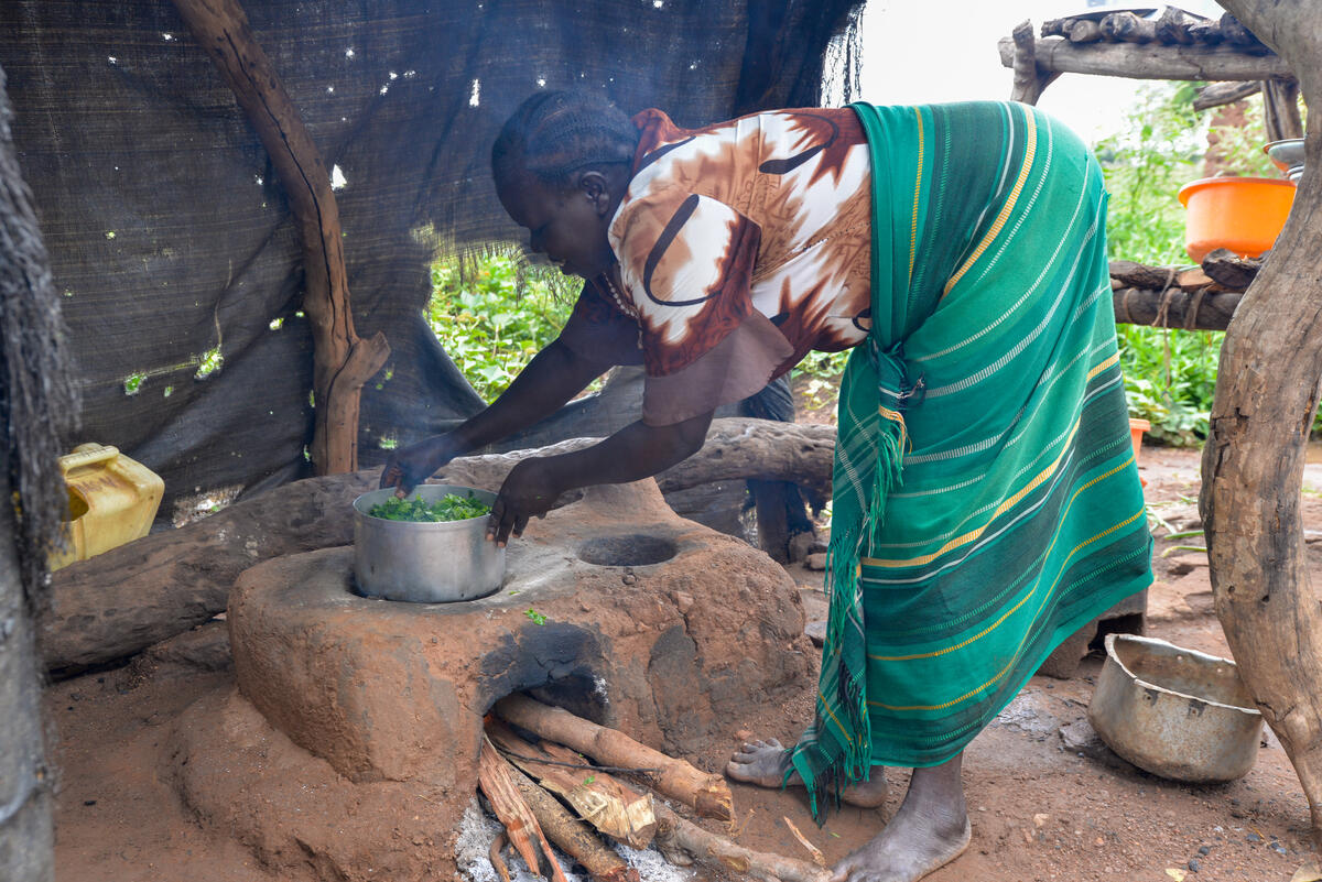 Woman cooking dinner for her family in Uganda