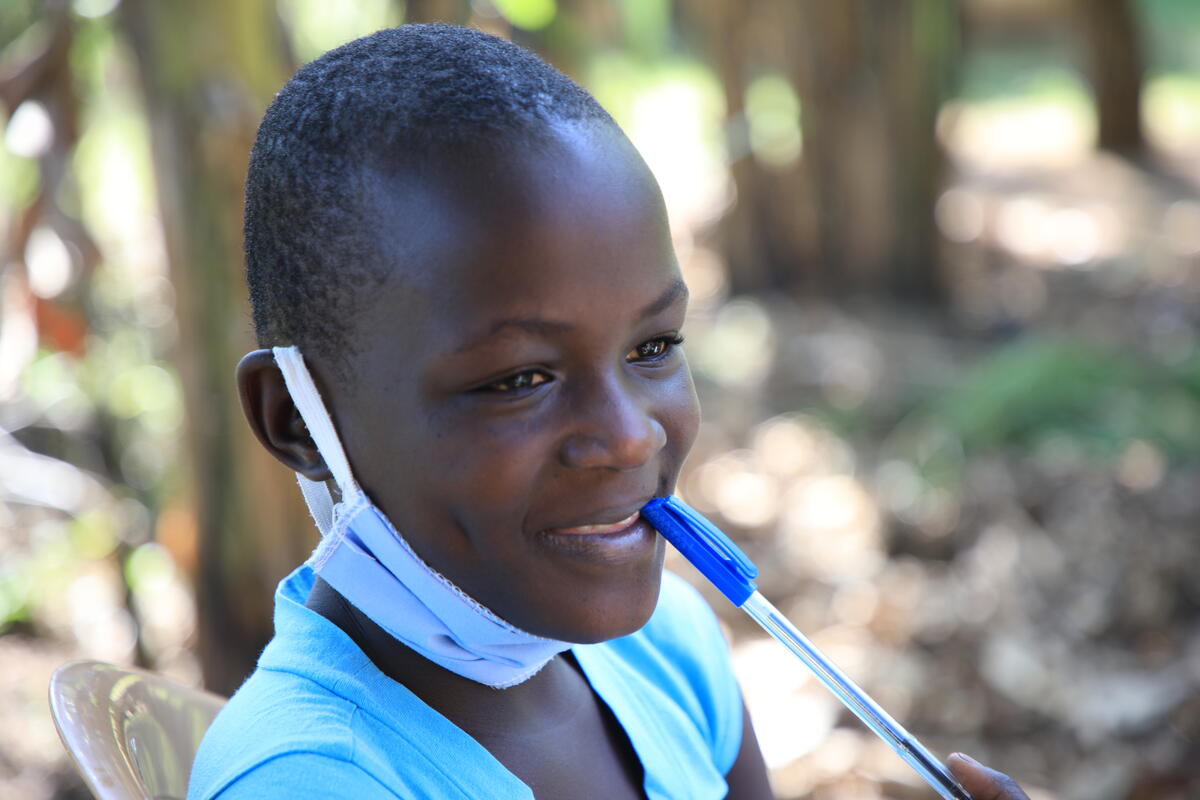 sponsored child works on writing a letter