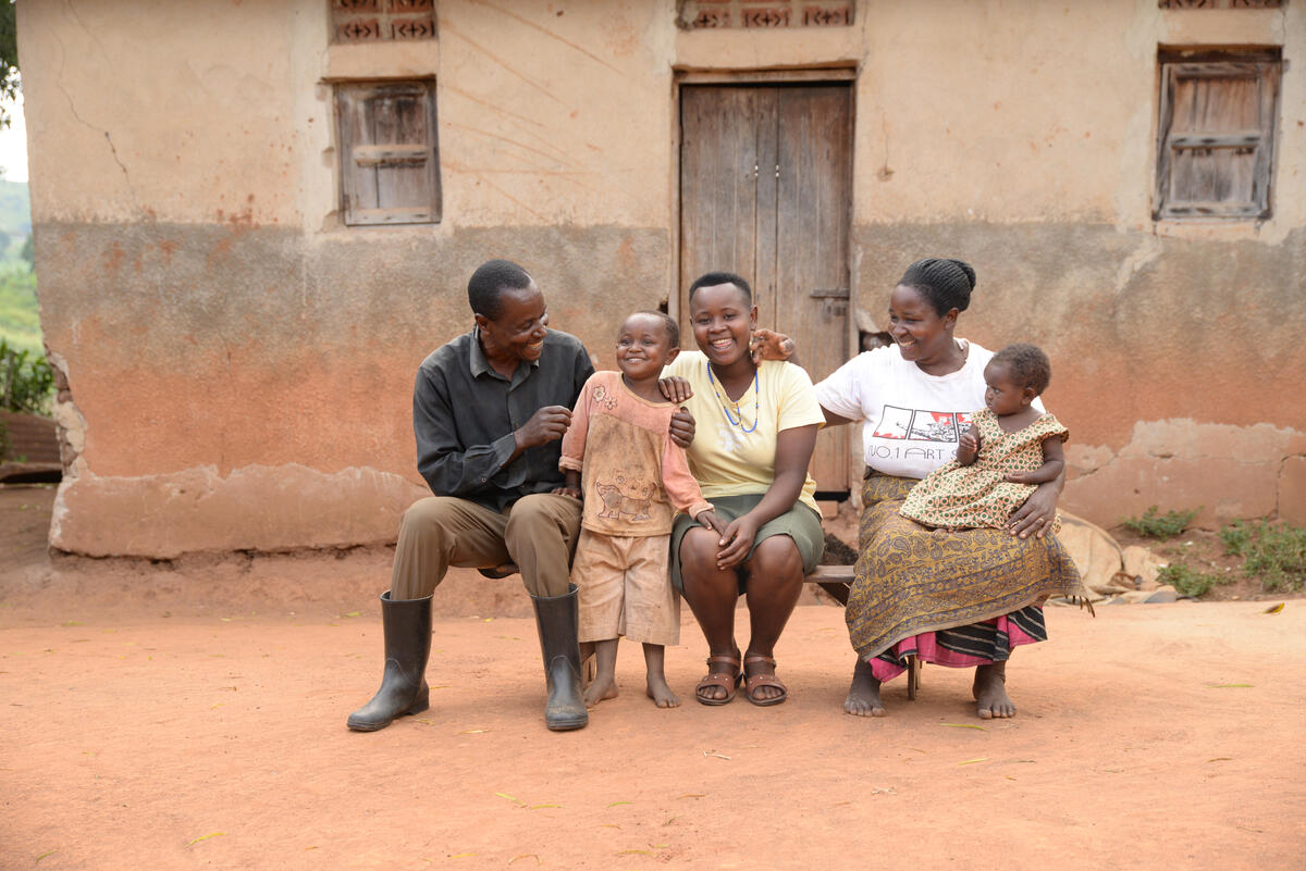 Juliet sits with her family in Uganda