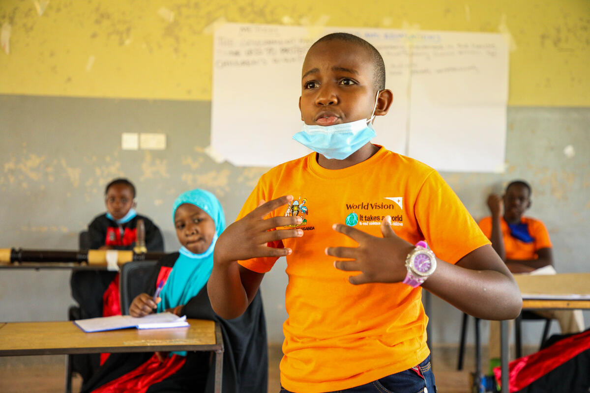 Justice, 15-year-old, Ugandan boy who aspires to be a lawyer.