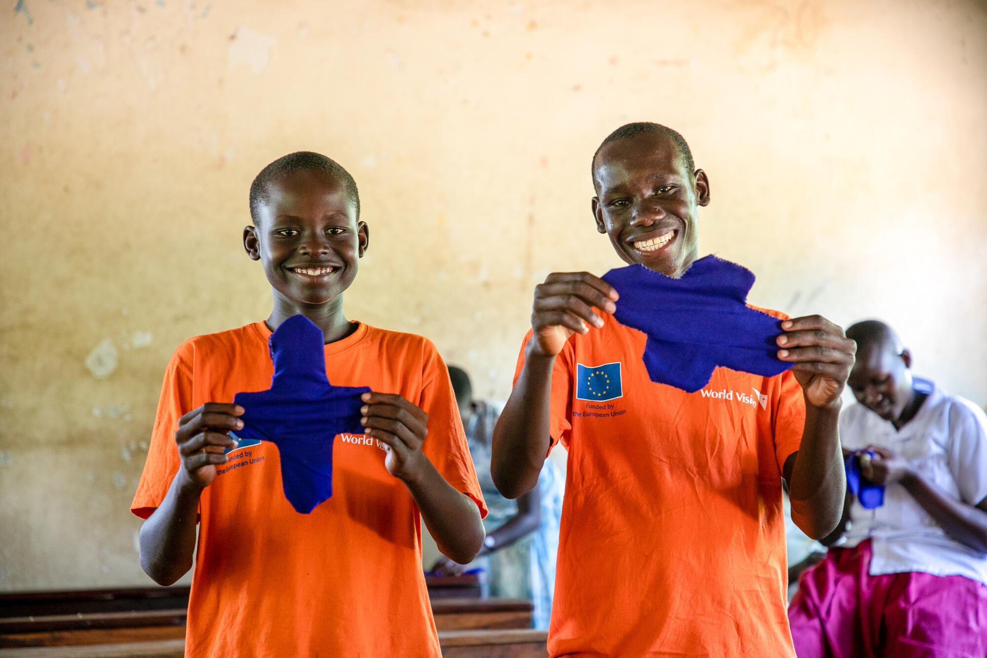 Joseph (R) and Jonathan (L) displaying the reusable menstrual kits that they made