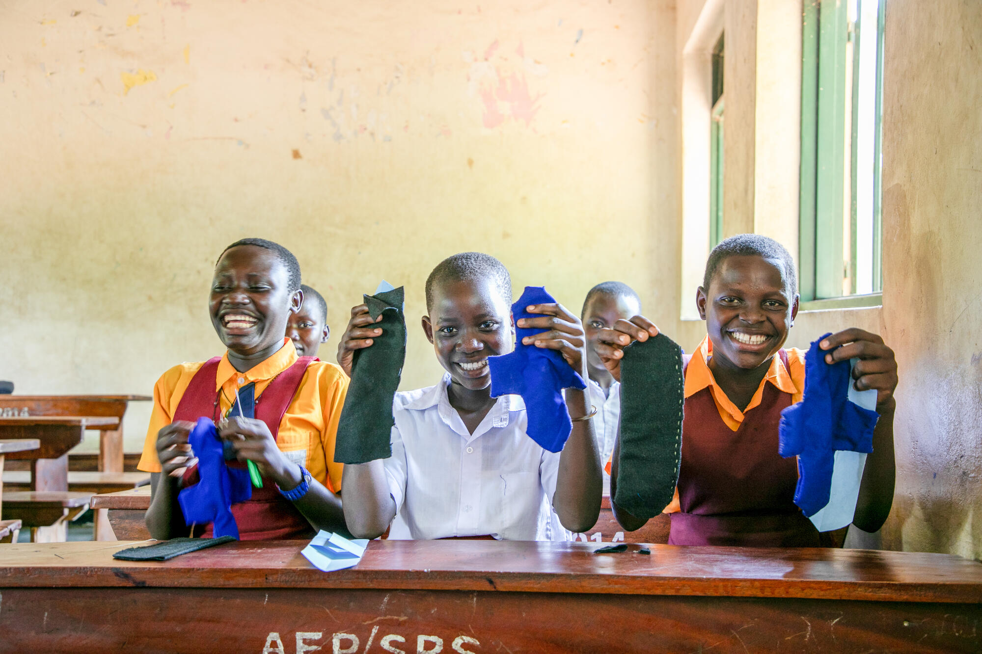 Sylvia (R), Winnie (C) and Juliana (L) displaying their reusable hygiene kits.