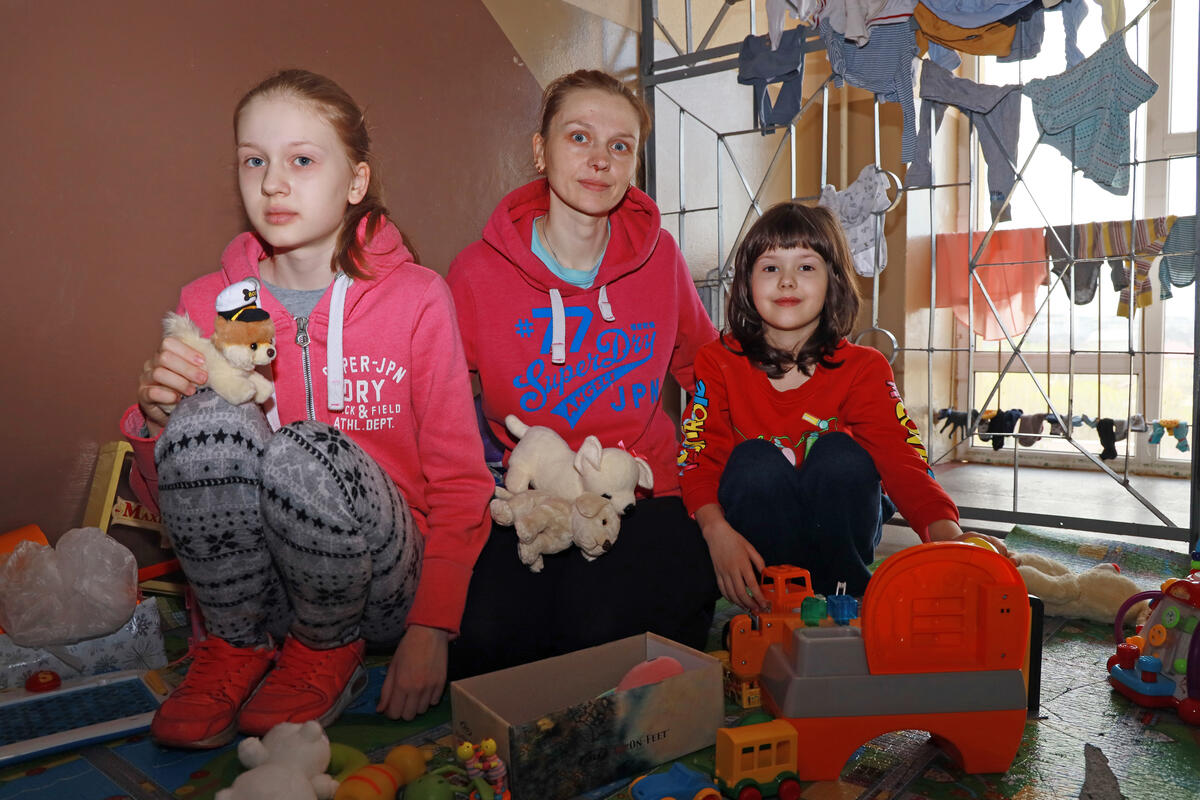 Xenia, child refugee from Ukraine sits in a shelter with her other and sister and talks about how they traditionally celebrated Easter