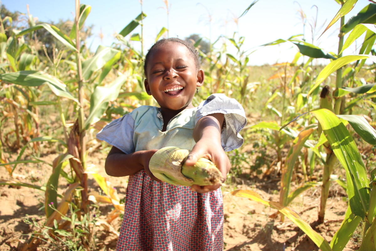 Naomi shows the fruits of her family's labour on their farm