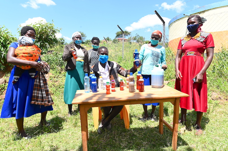 Stella displays the soap, sanitisers and disinfectants that her team of community health volunteers make in her village, thanks to the support provided by World Vision.