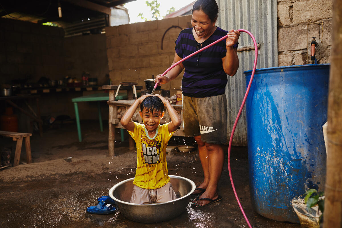 a mother showering her son