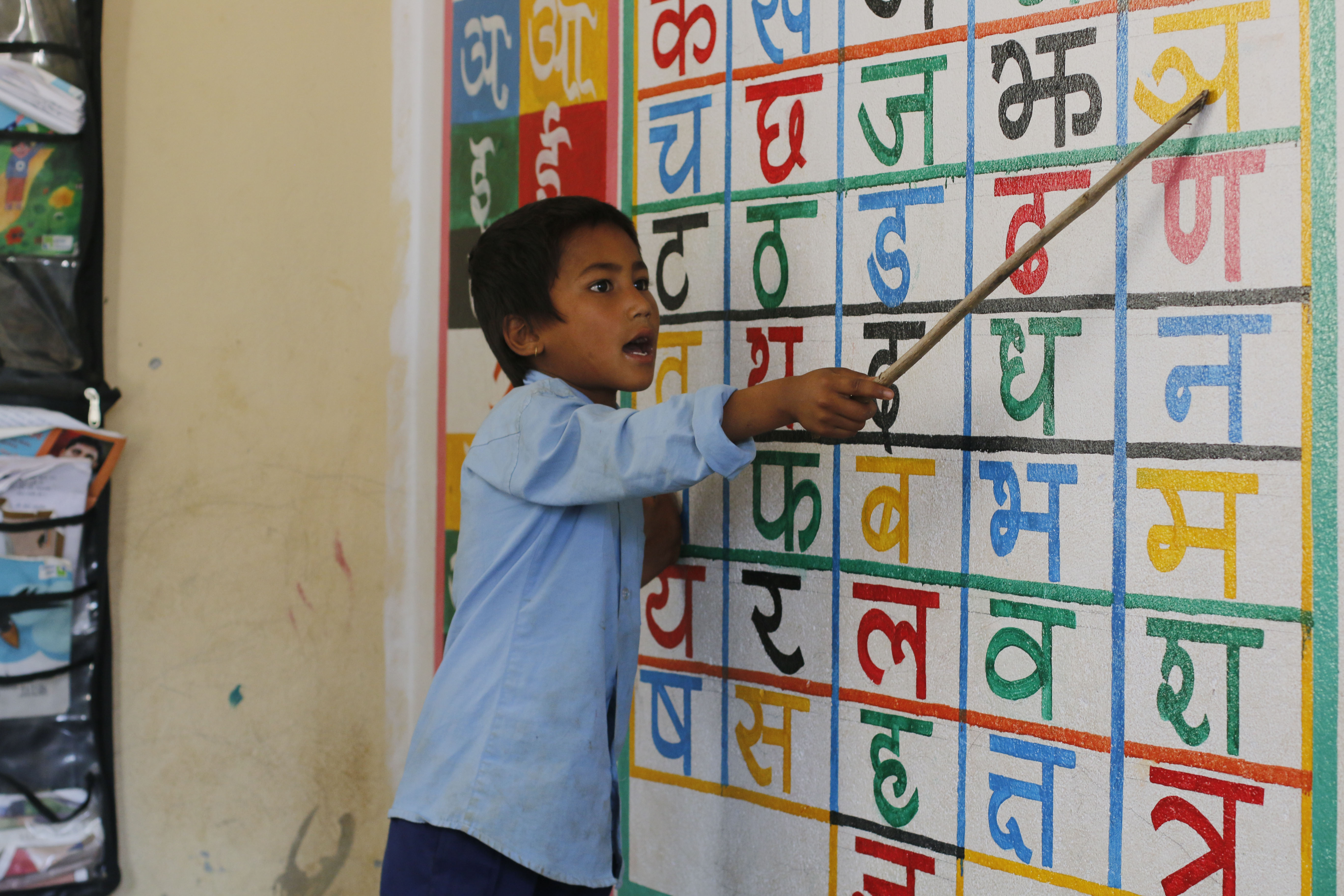 Hom Bahadur, a first grader, enthusiastically leads his friends in a class activity.
