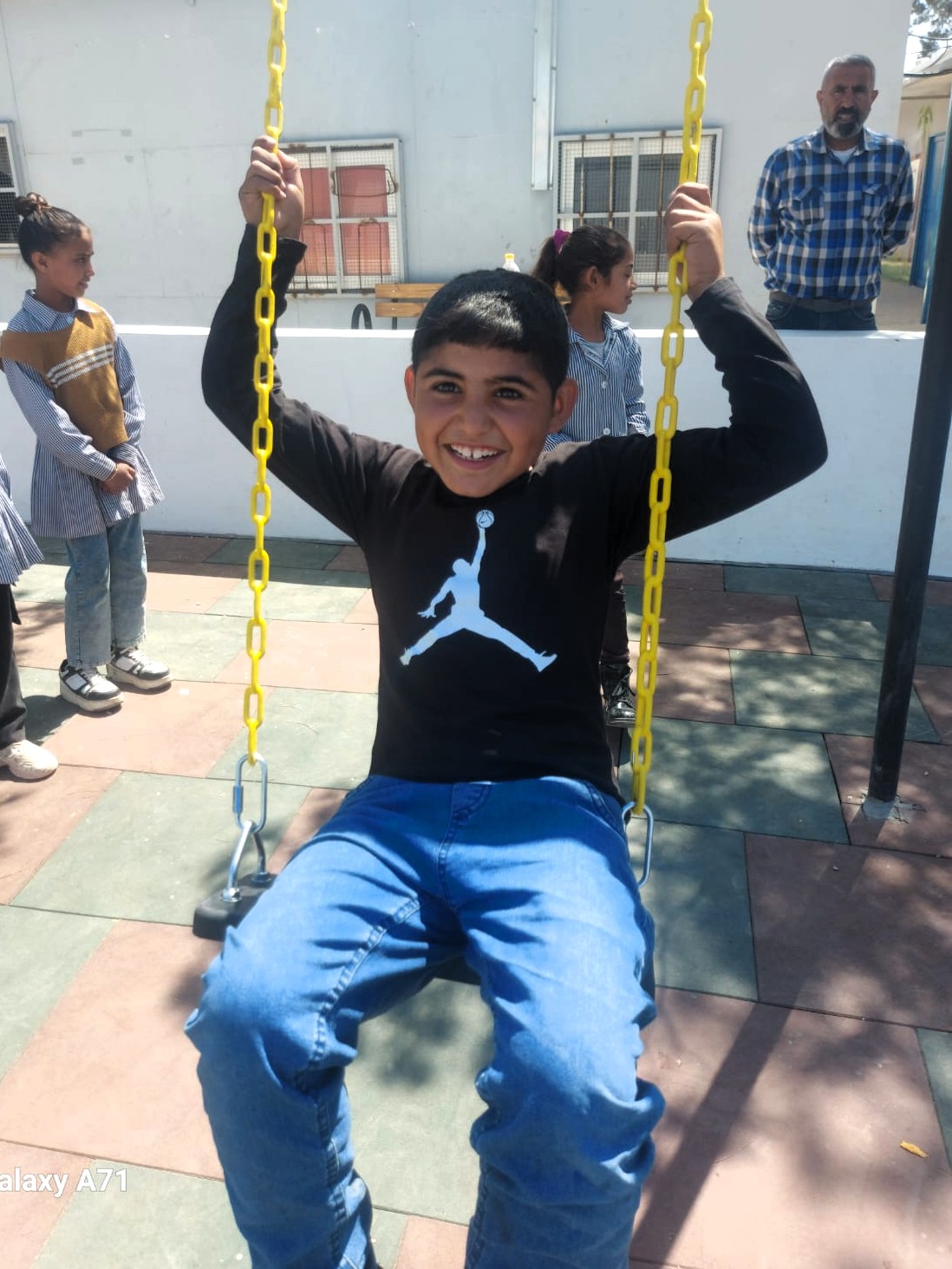 Salem, 11, plays in the new playground