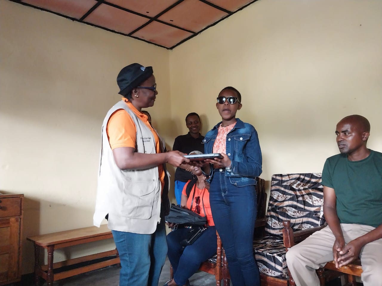 World Vision Internation Rwanda National Director handing over a laptop to Denise to support her education.
