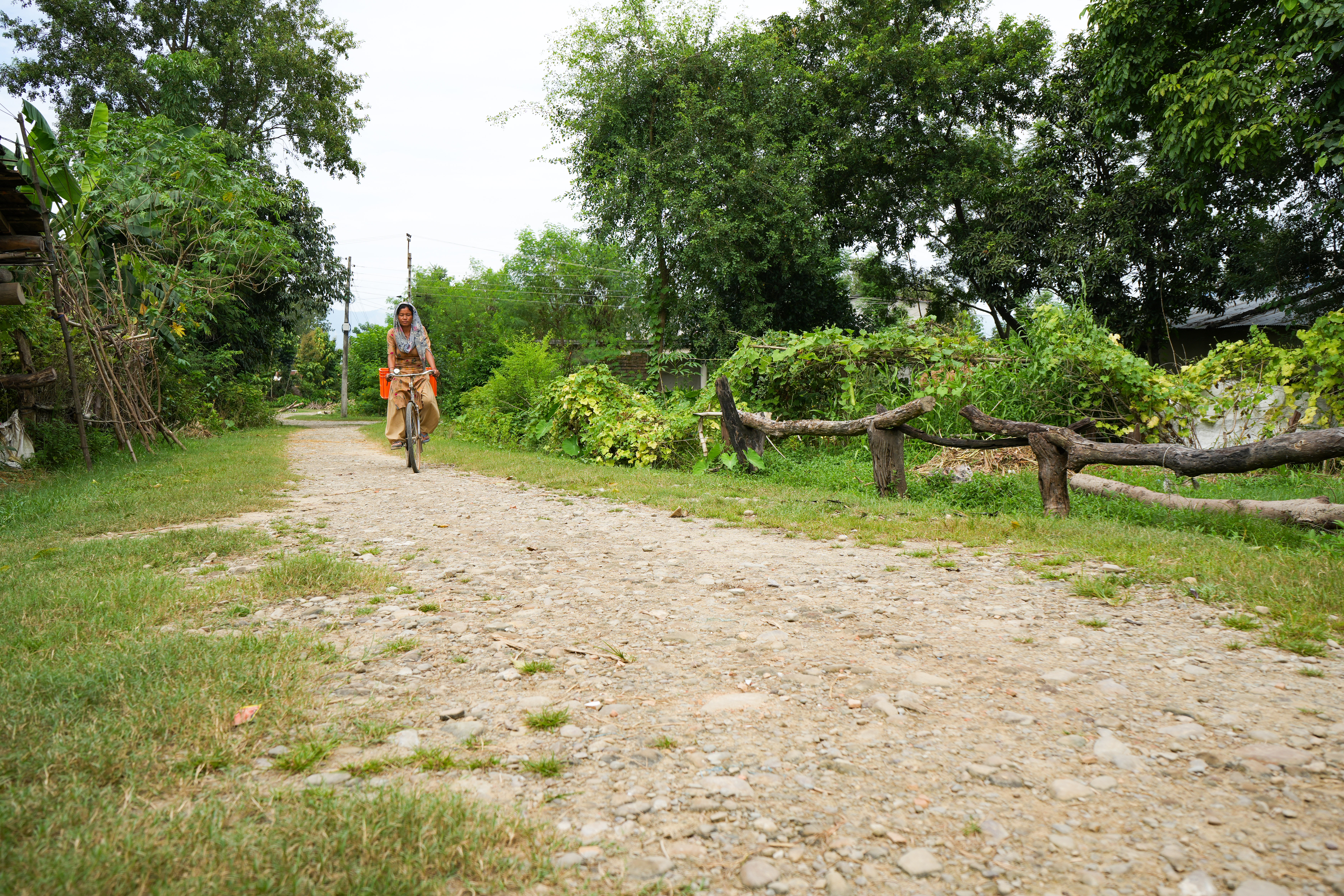 With the savings, Sundari cycles to the market to sell the vegetables from her farm