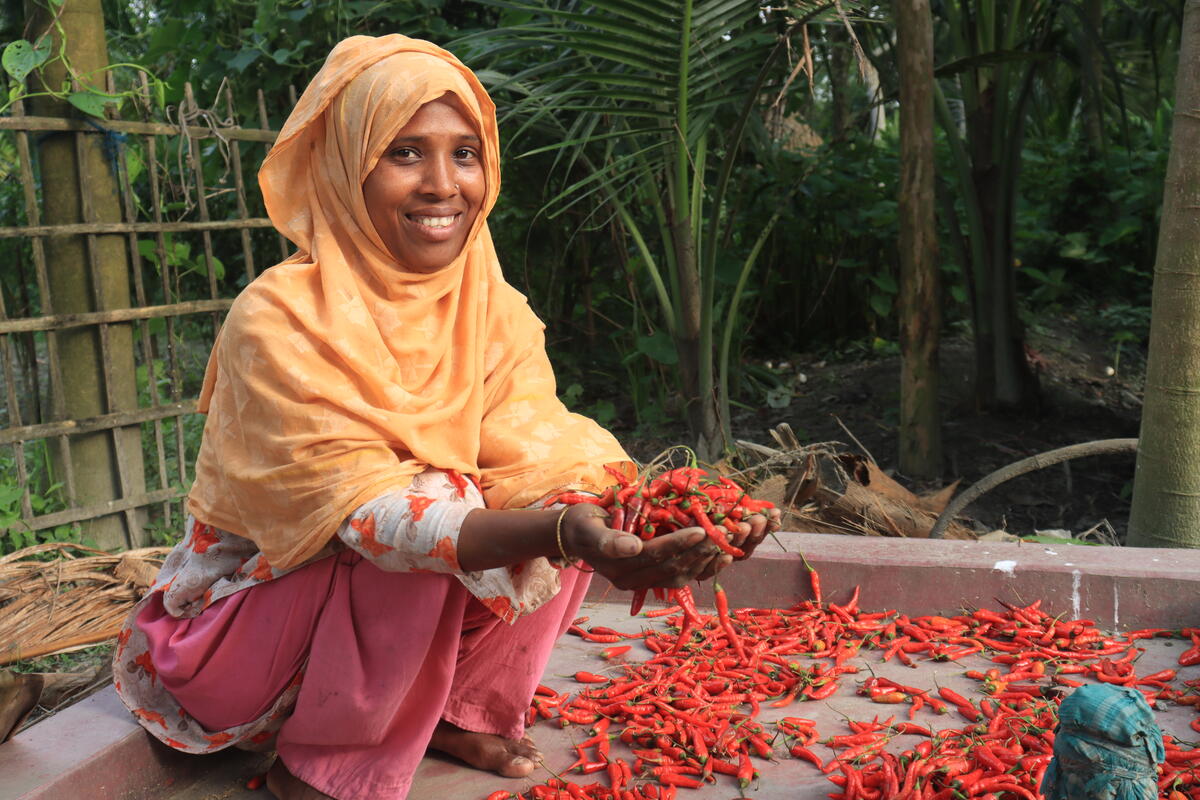woman holding chillies