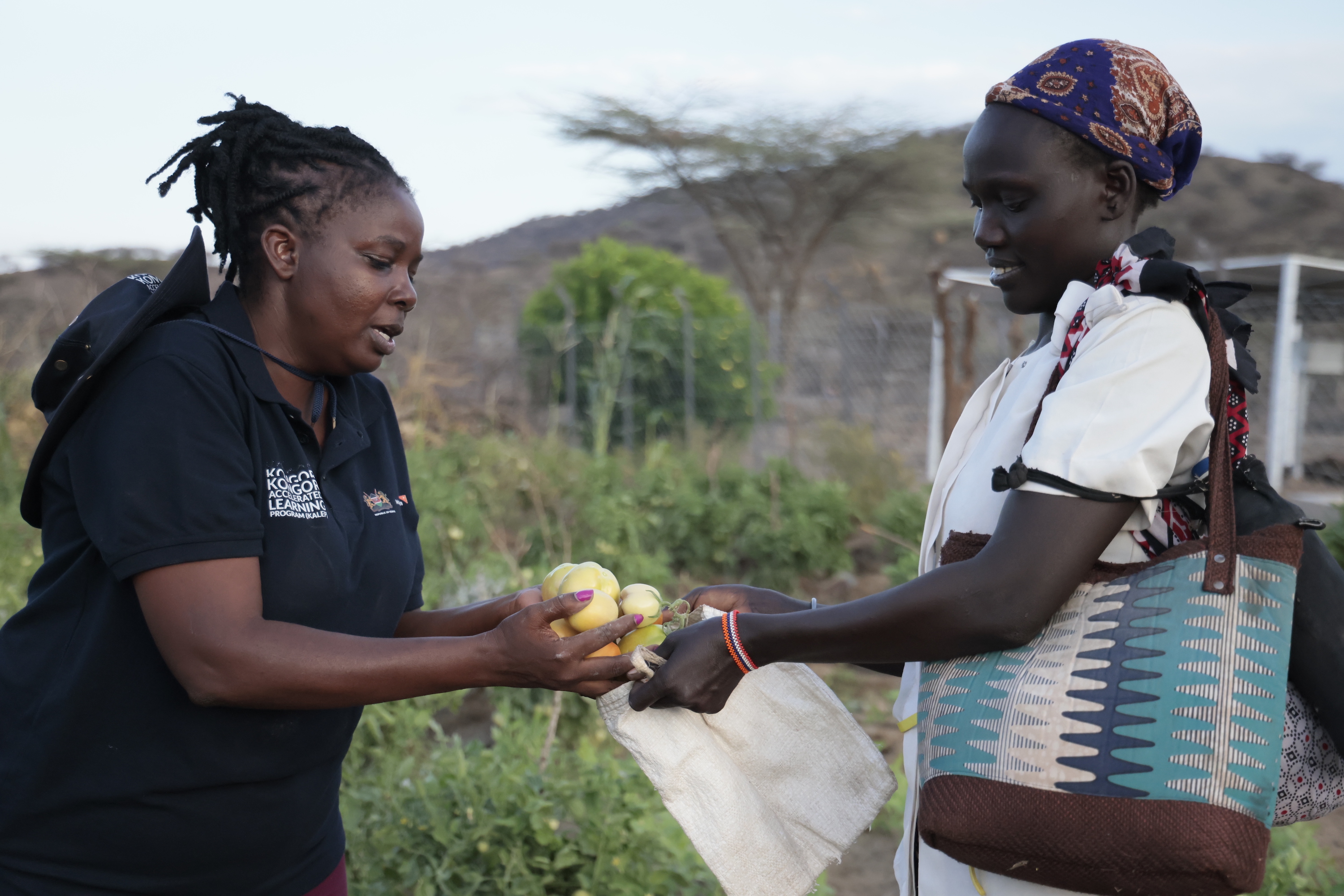 Lorus and World Vision's Project Officer Leah Musyoka with some of the produce from the farm