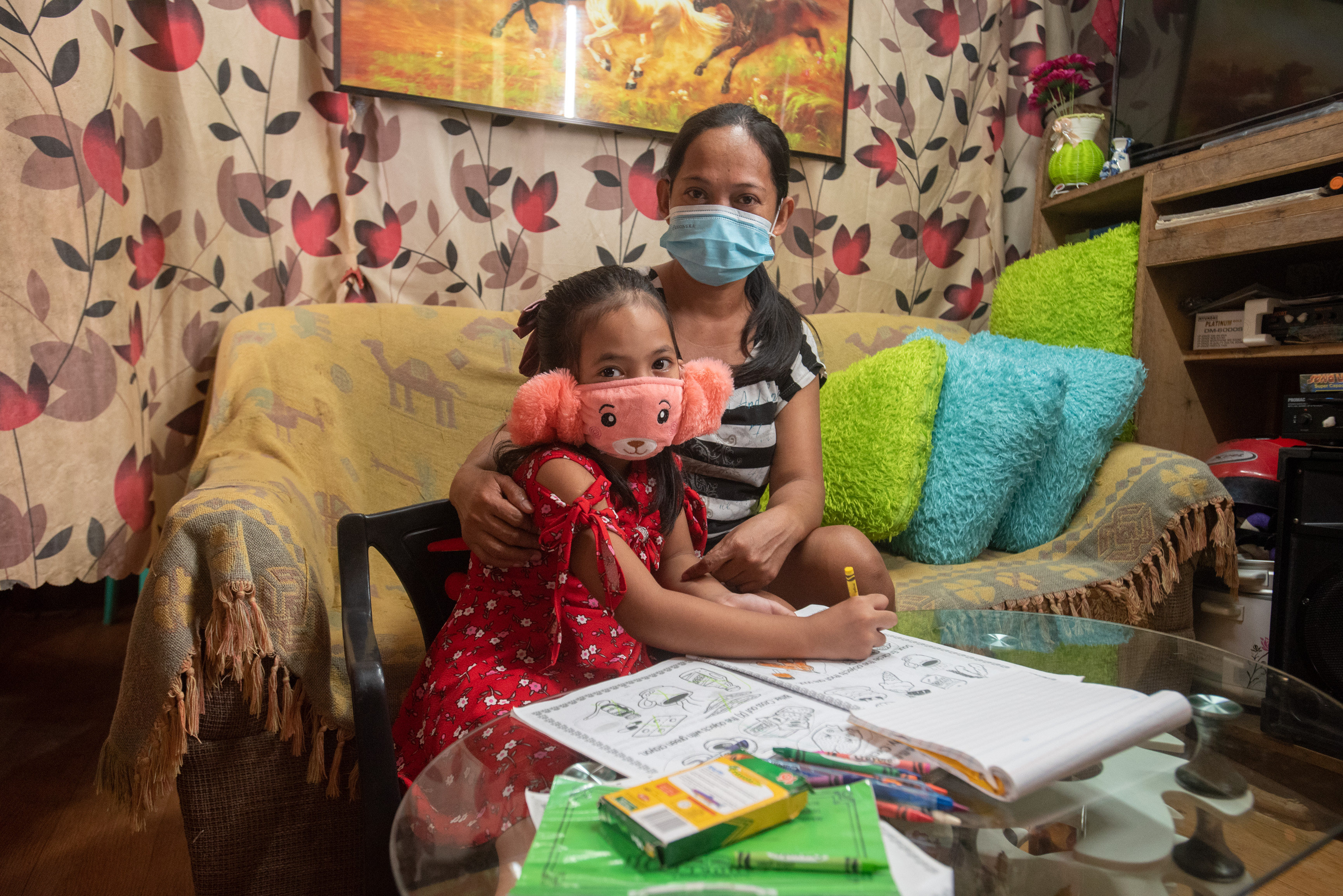 Patricia and her mother at home as she works on her homework.