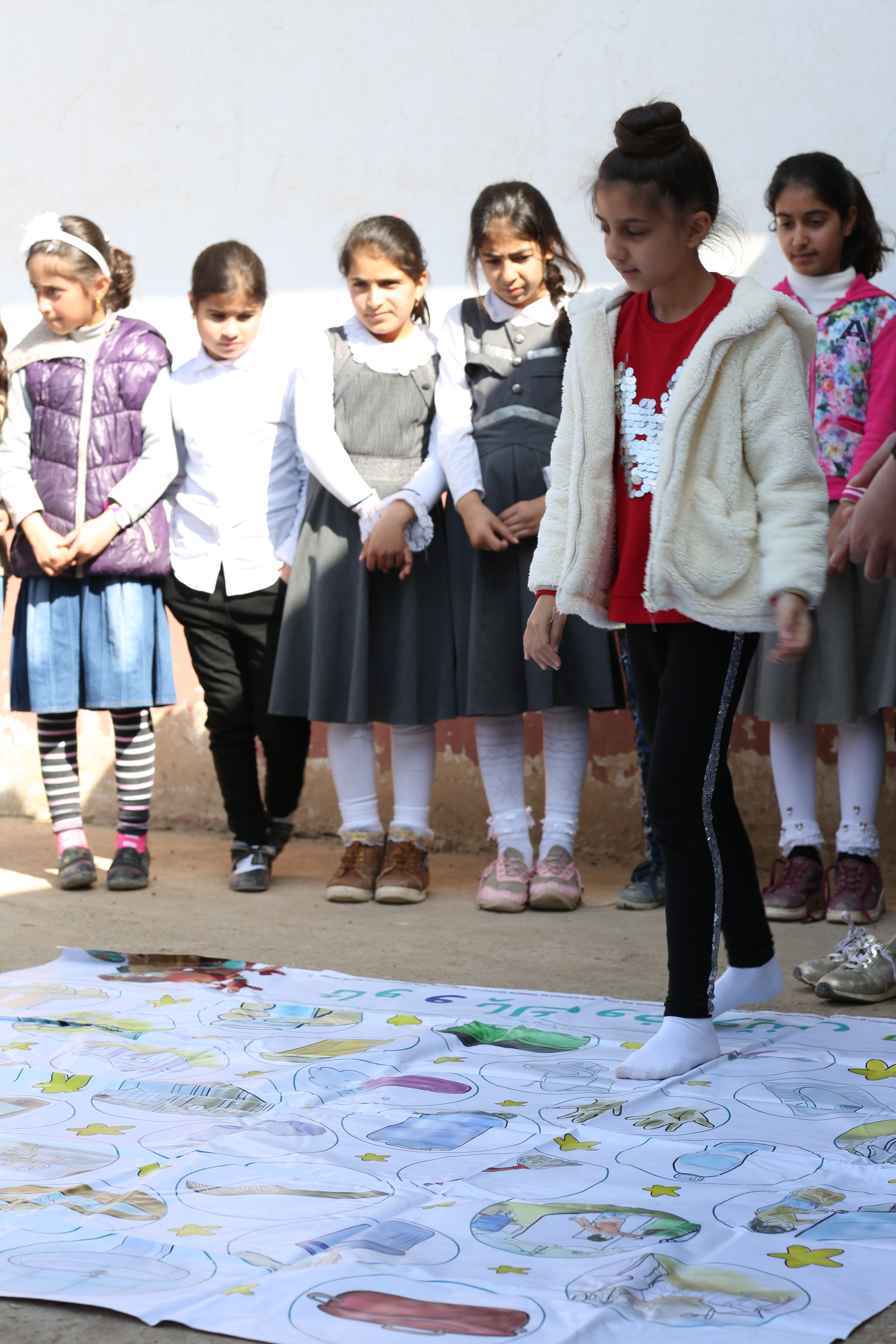 Zahraa and her school mates during a WASH Up! play session