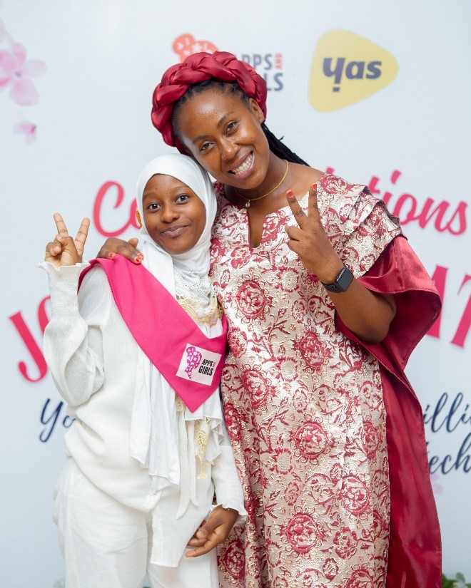 Zuwena (left) and Carolyne Ekyarisiima, Executive Director, Apps for Girls, pose together during the graduation ceremony. (Photo credit: World Vision Tanzania)