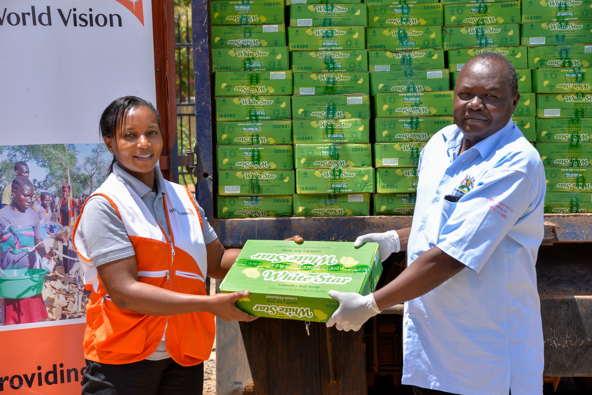 The Refugee Response Director, Mary Njeri handing over soap to an official from the Office of the Prime Minister 