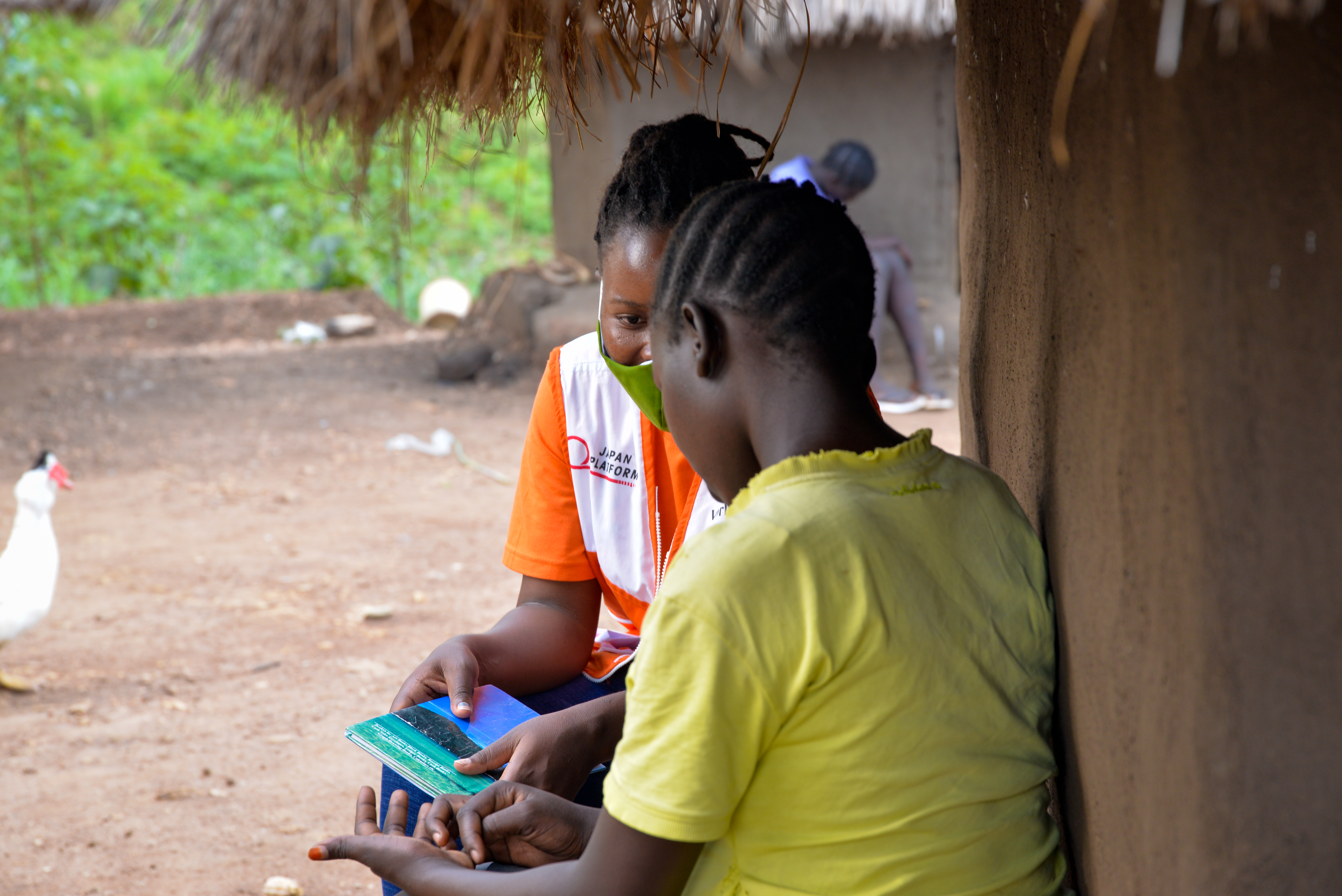 Lucy speaking to one of the World Vision case workers