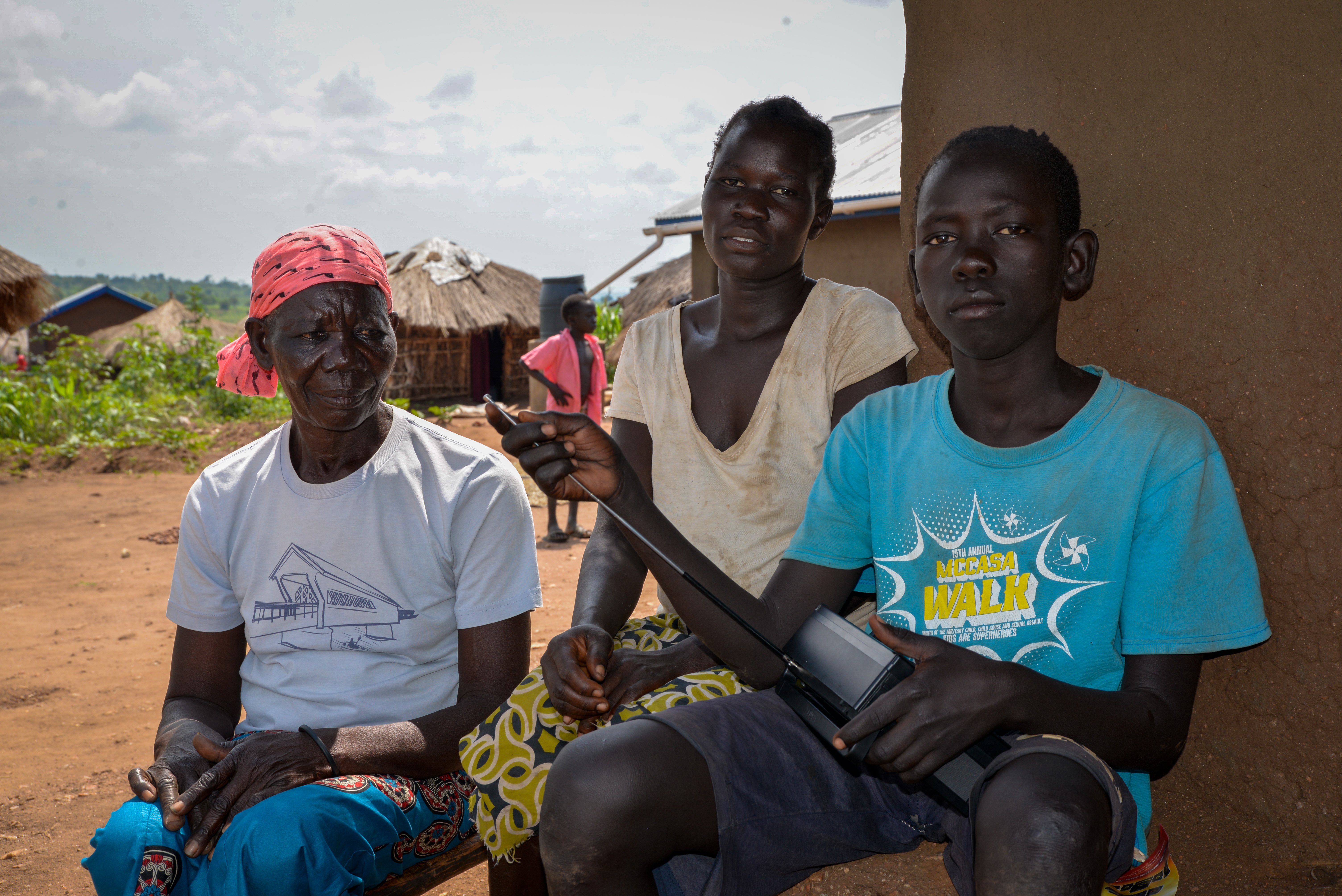 Isaac with his grandmother (left) and his foster mother Sara Kegi (Middle) at their home Yoyo village, Bidibidi 