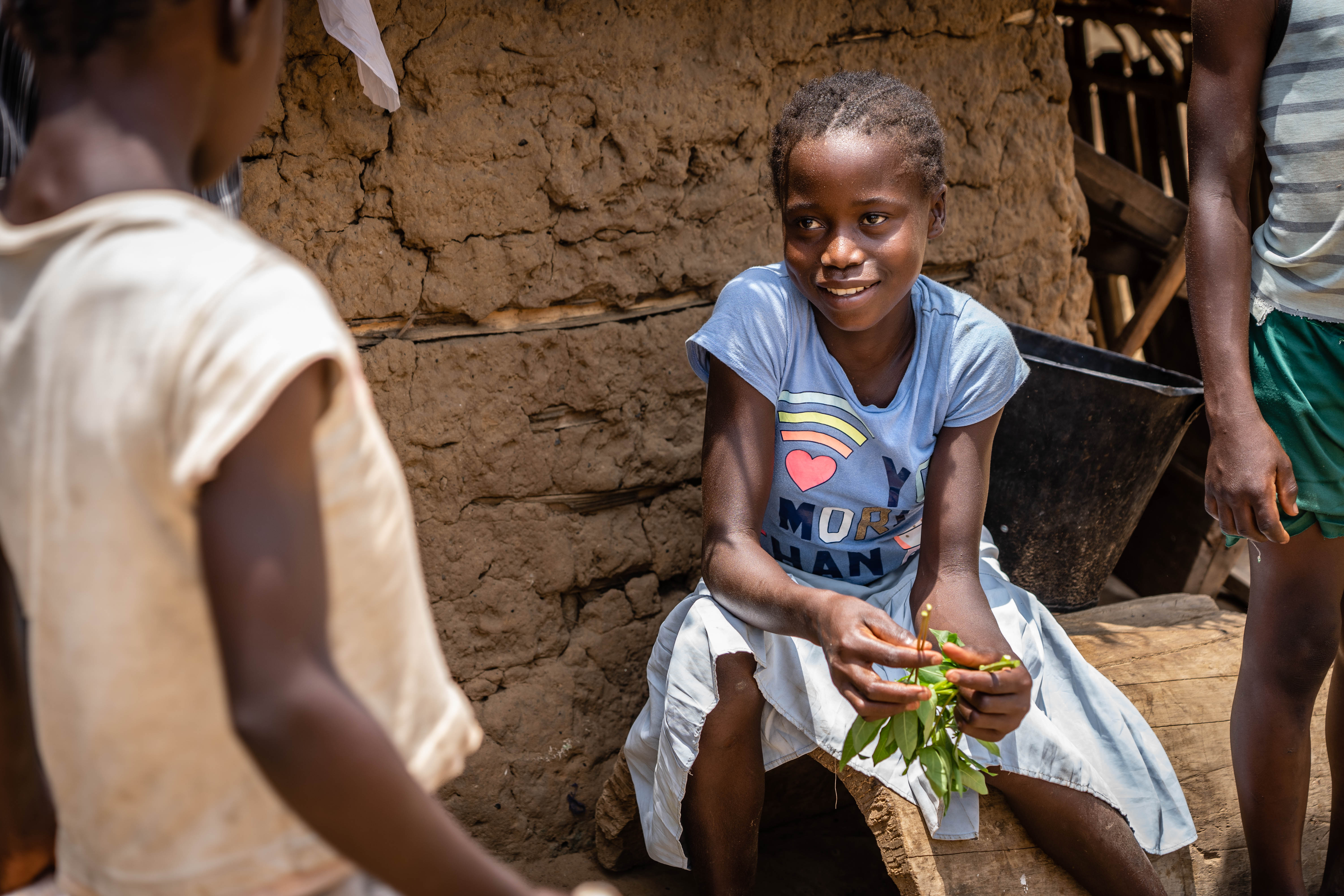 Romanie engages in family chores, like preparing vegetables for a meal