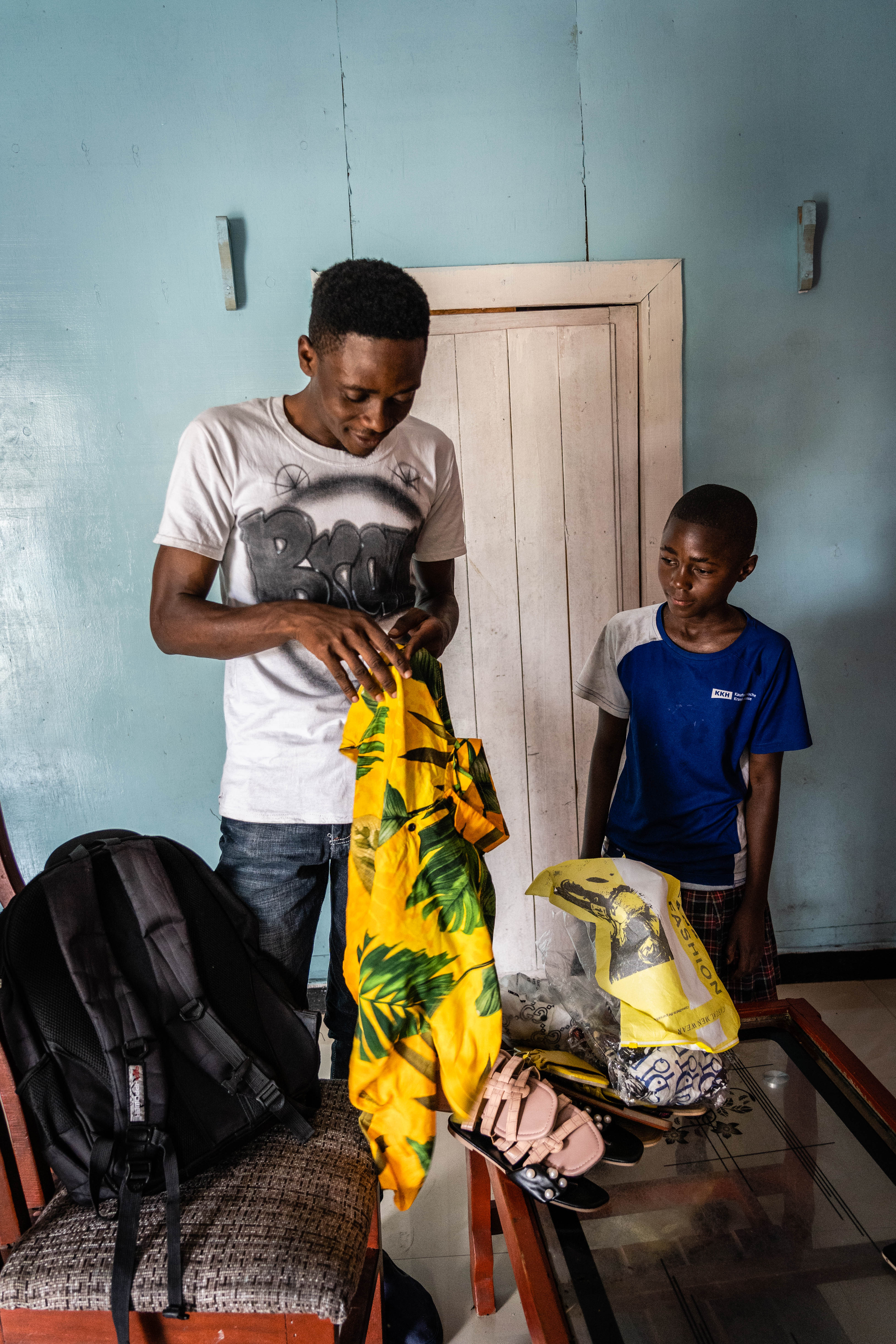 Emmy and Andre, a family friend, who helps her family vend clothes on the streets