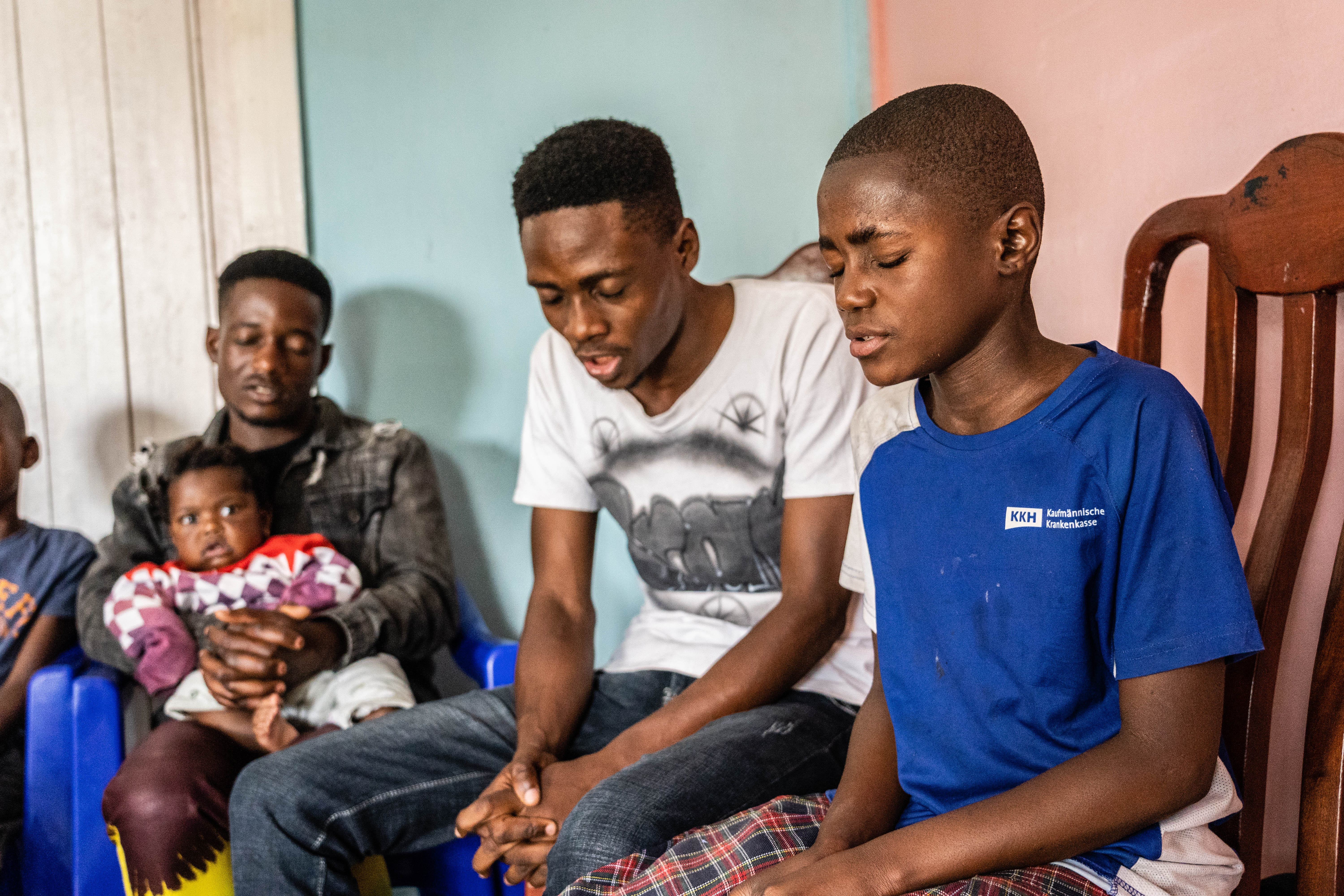 Emmy (in blue t-shirt) prays that God provides for her parents, so that she and her siblings can continue with school