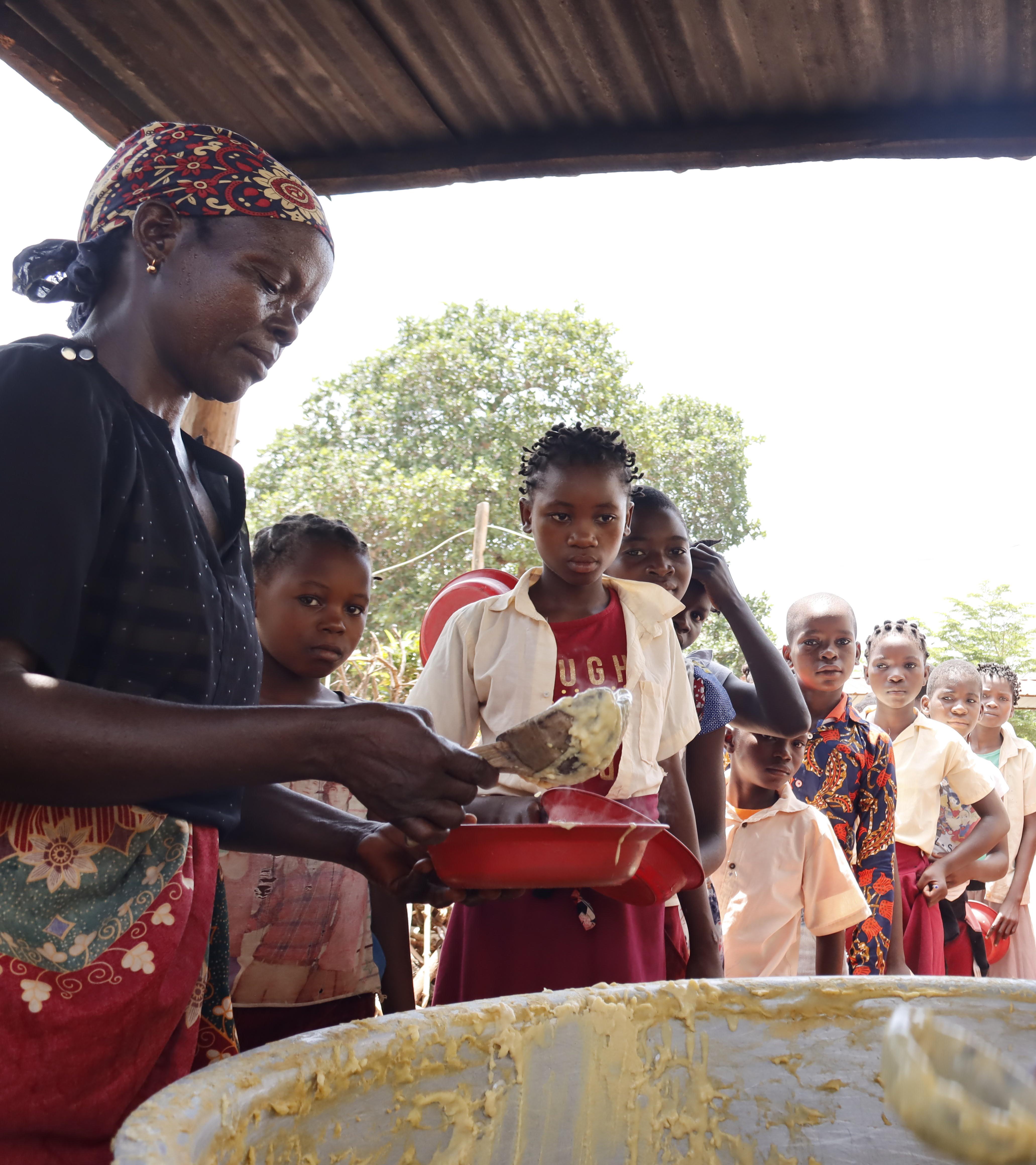 Children in line to get their fortified porridge 