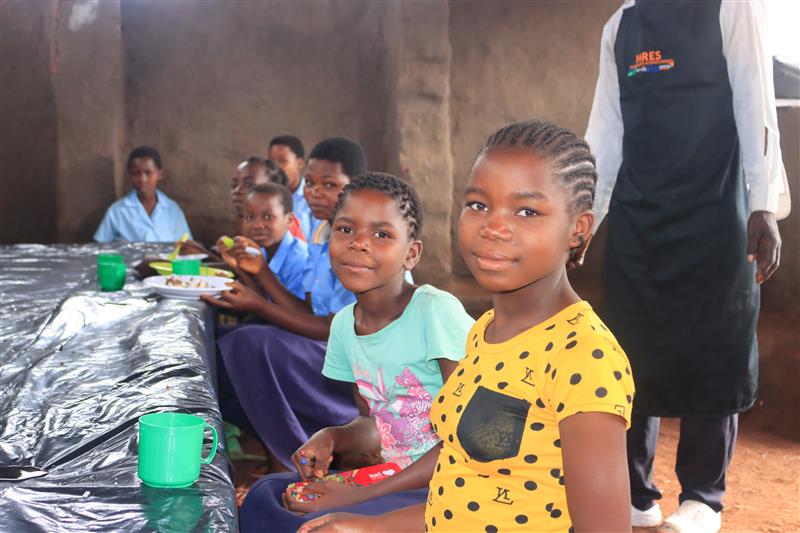 Young Gilda in the yellow shirt, one of the first beneficiares of the school meals program in Zambezia