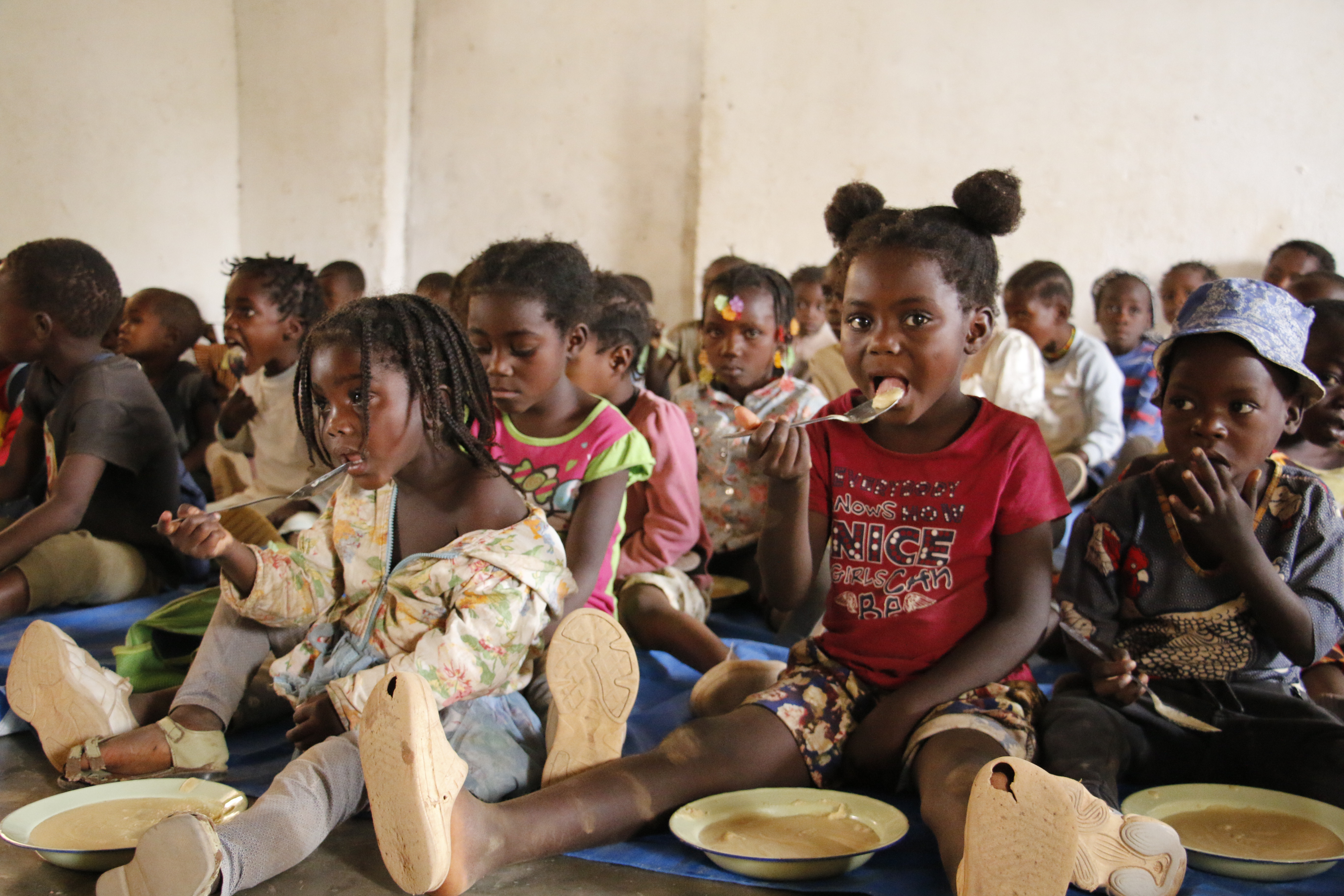 Children eating porridge at the Community Kitchen